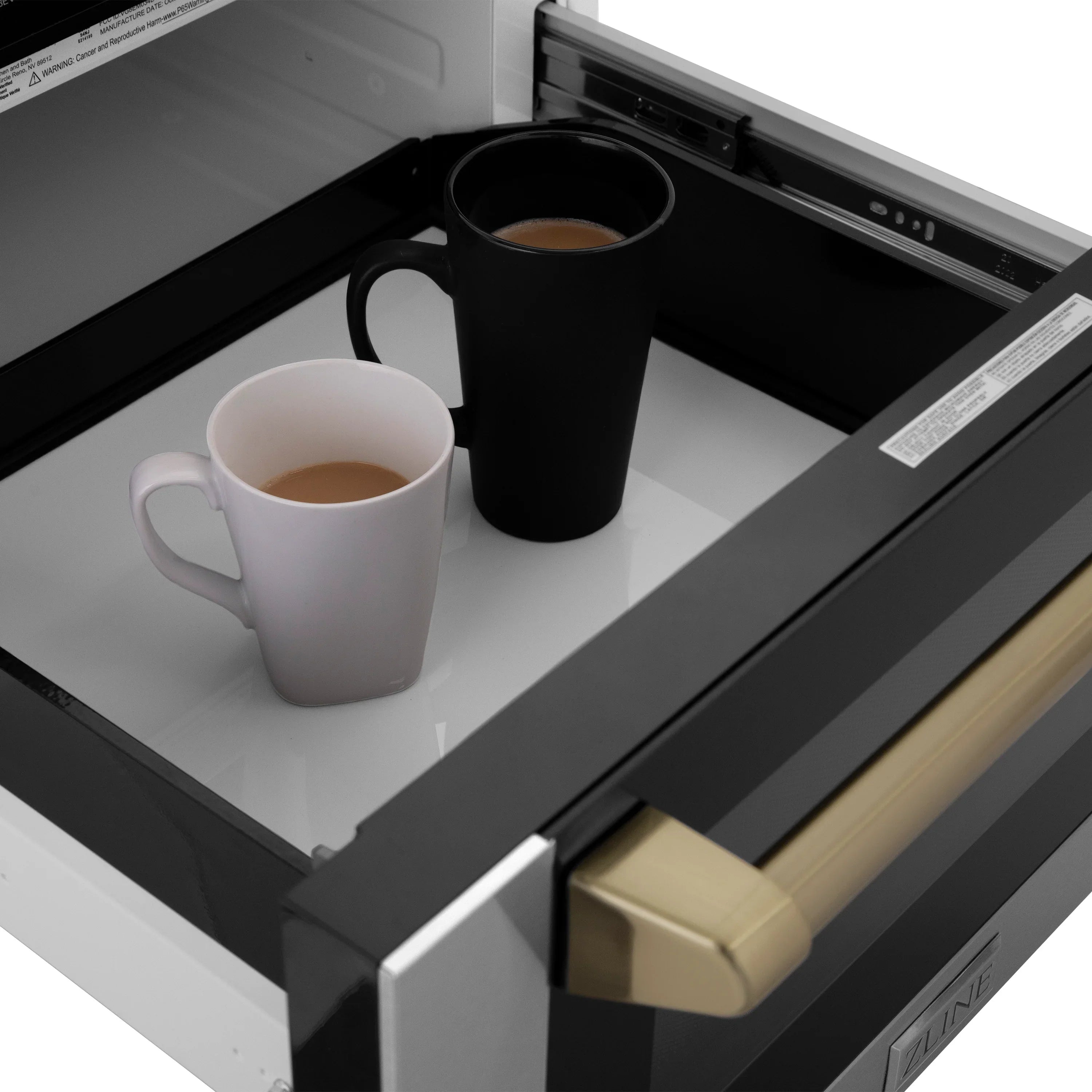 Microwave drawer interior with two mugs and a turntable tray