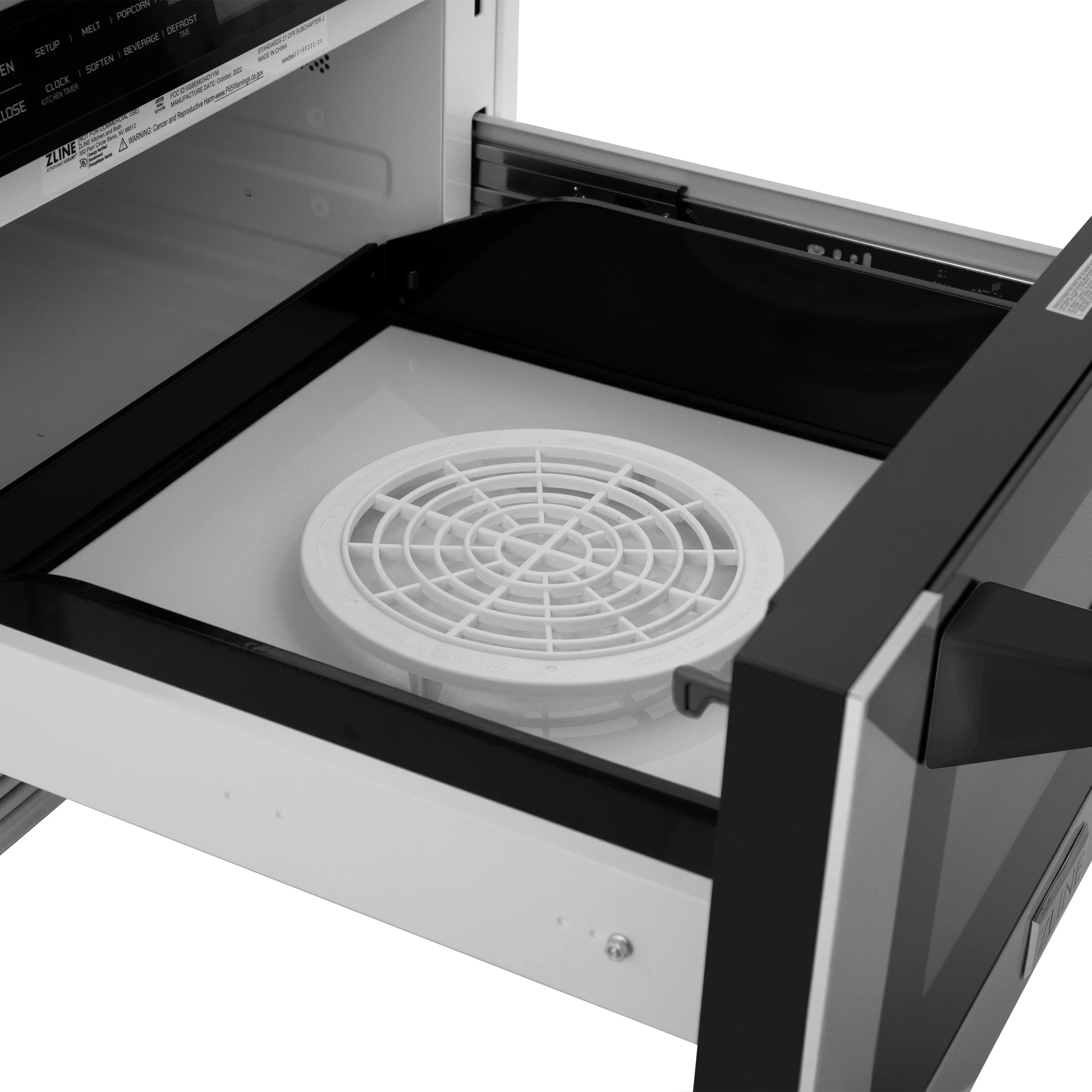 Microwave drawer interior with white turntable plate and vented base
