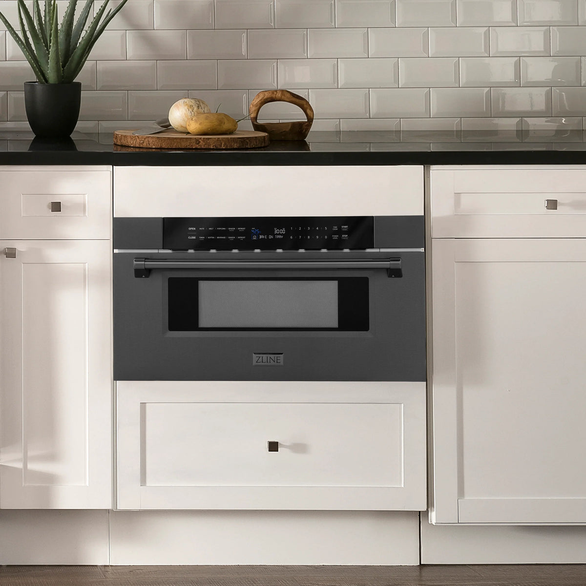 Black stainless microwave drawer installed in a kitchen undercounter setup