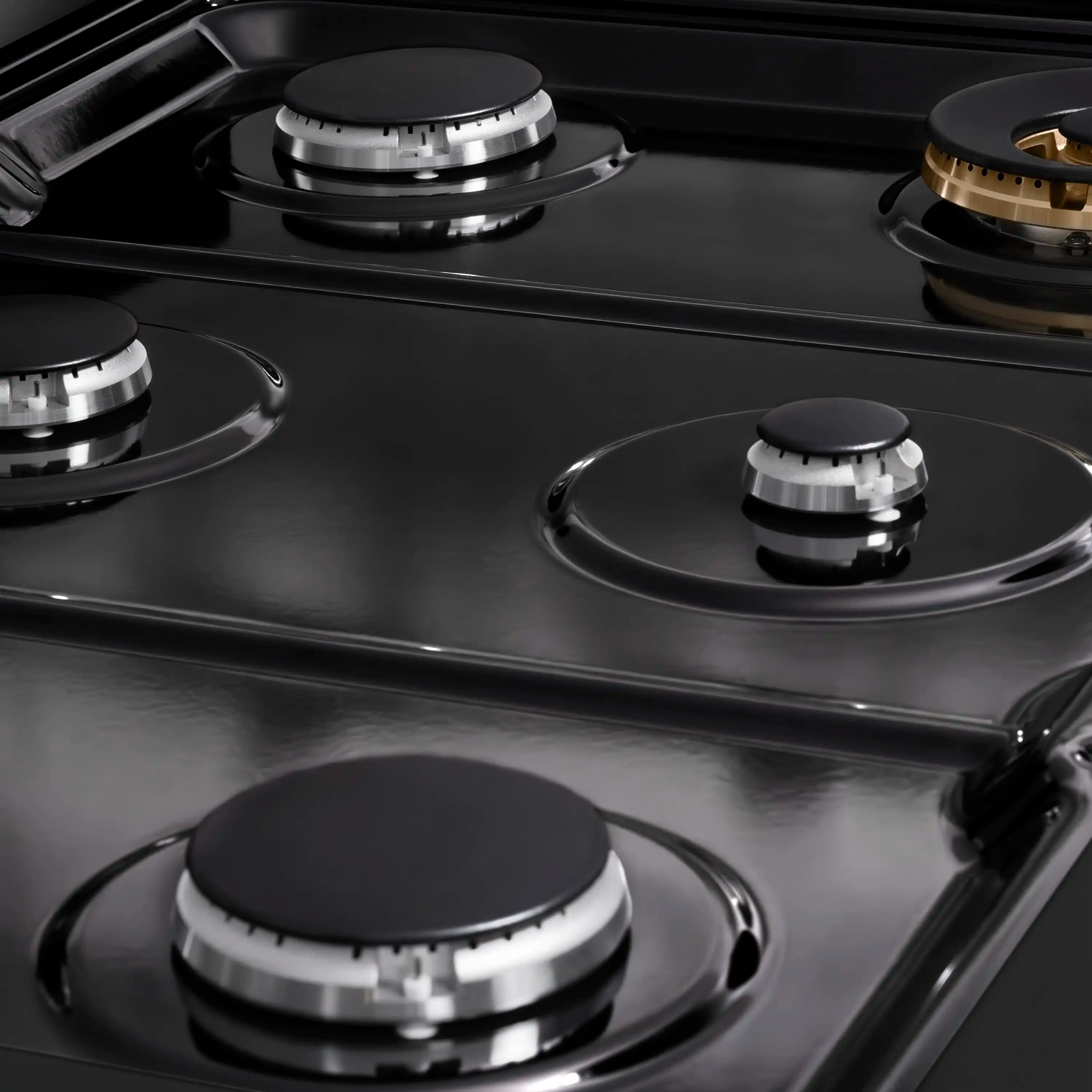 Black porcelain cooktop with multiple burner caps and circular burner rings