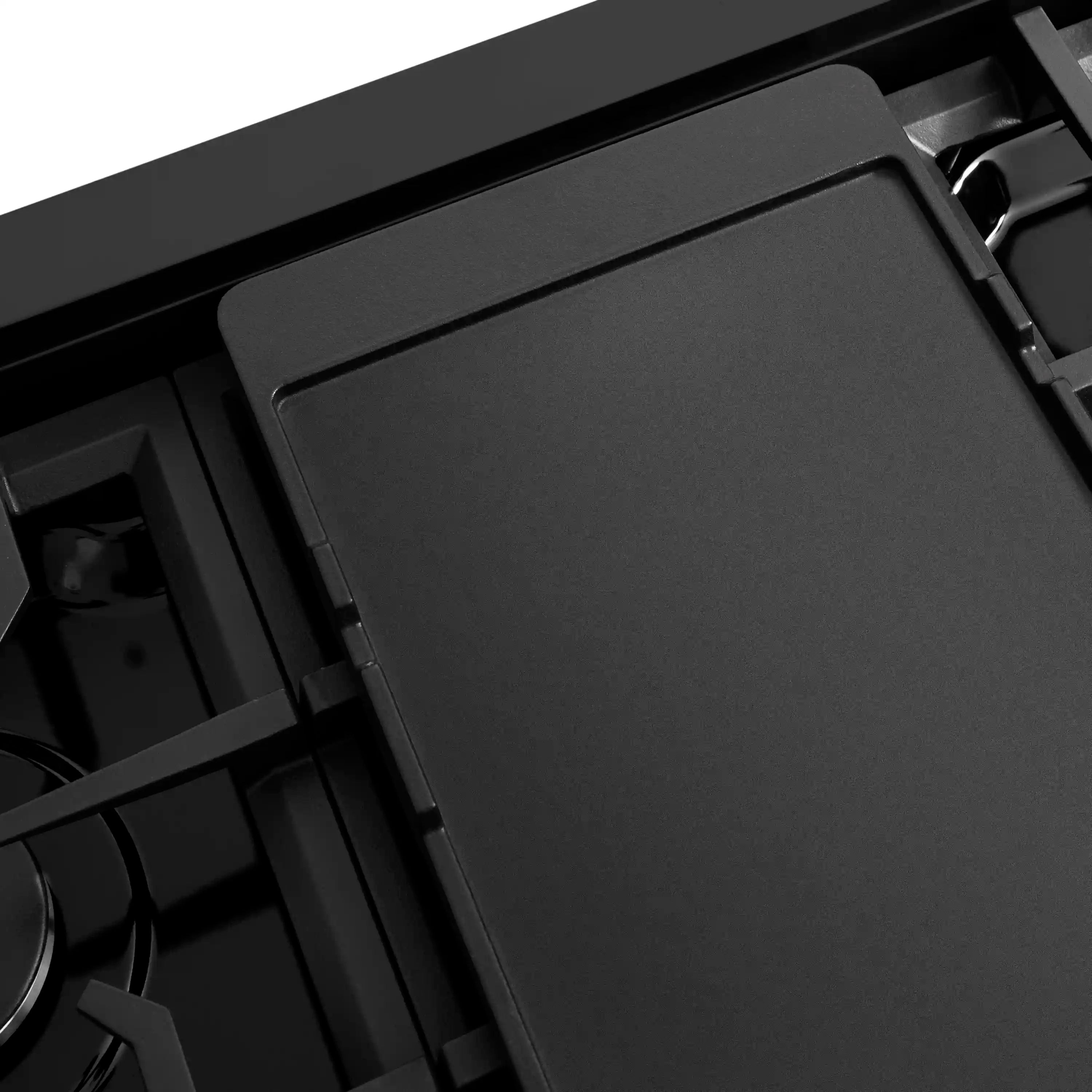 Black gas cooktop with a smooth rectangular burner cover in place