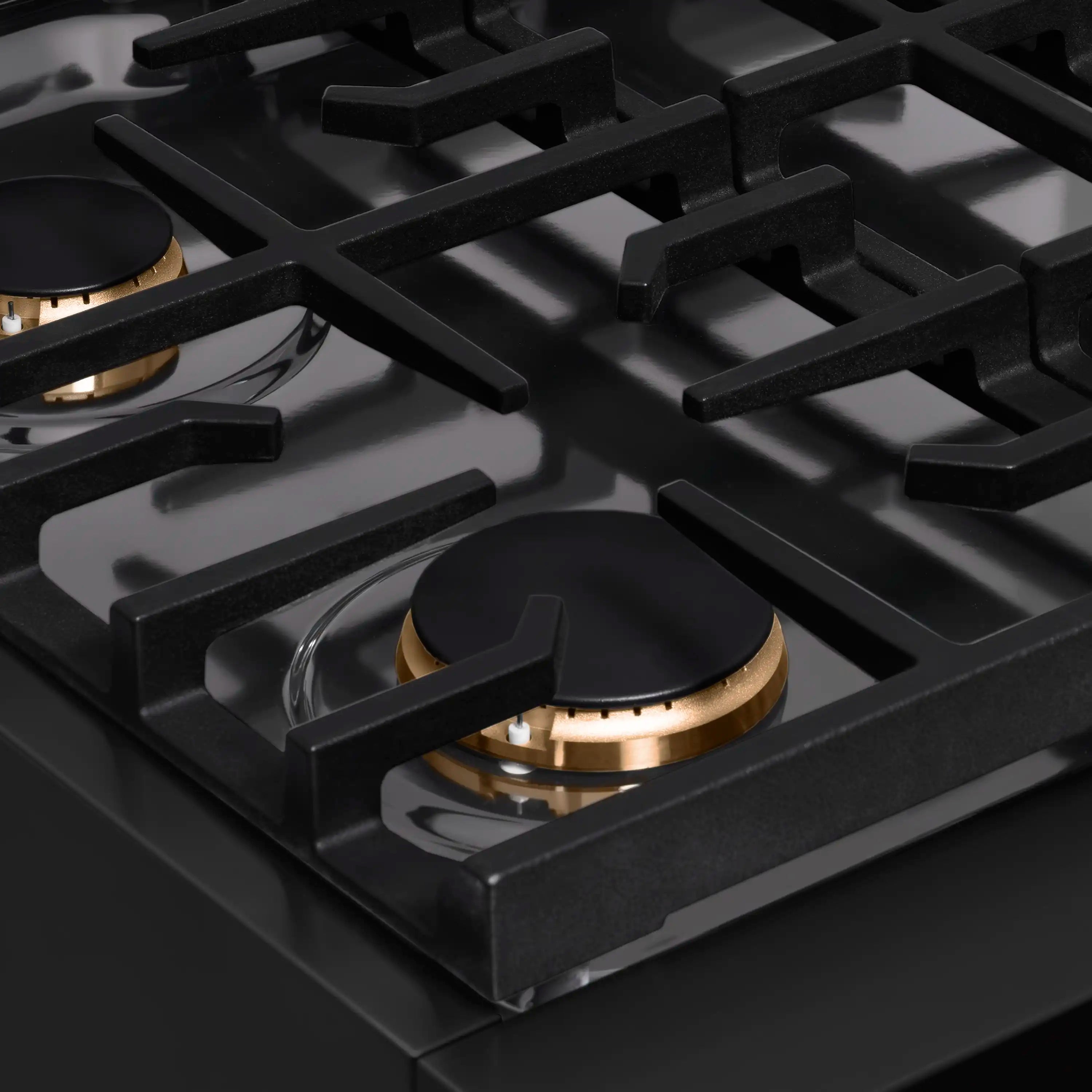 Black gas rangetop burner with black grate and polished gold burner ring accent