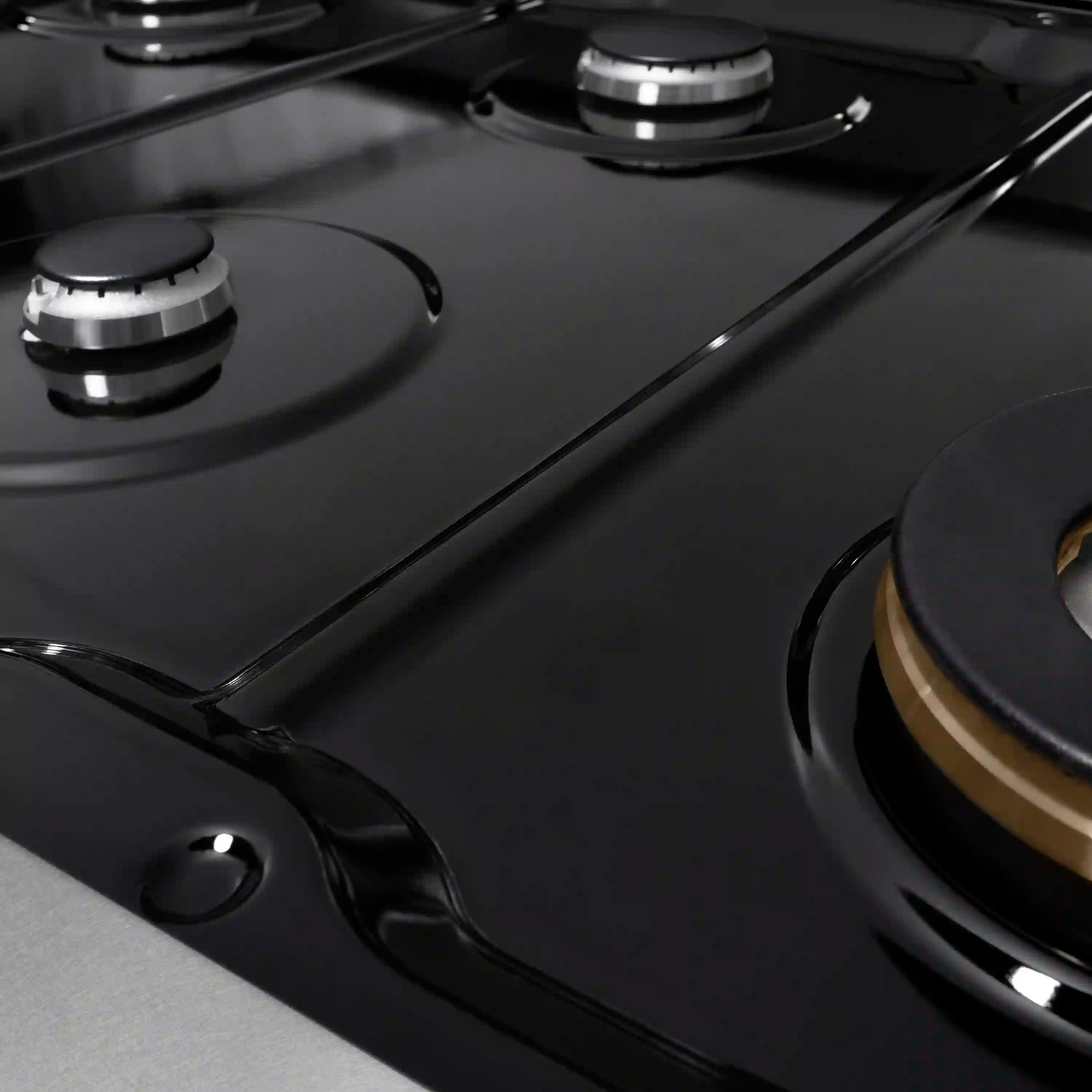 Satin stainless gas rangetop burner with black grate and control knob detail