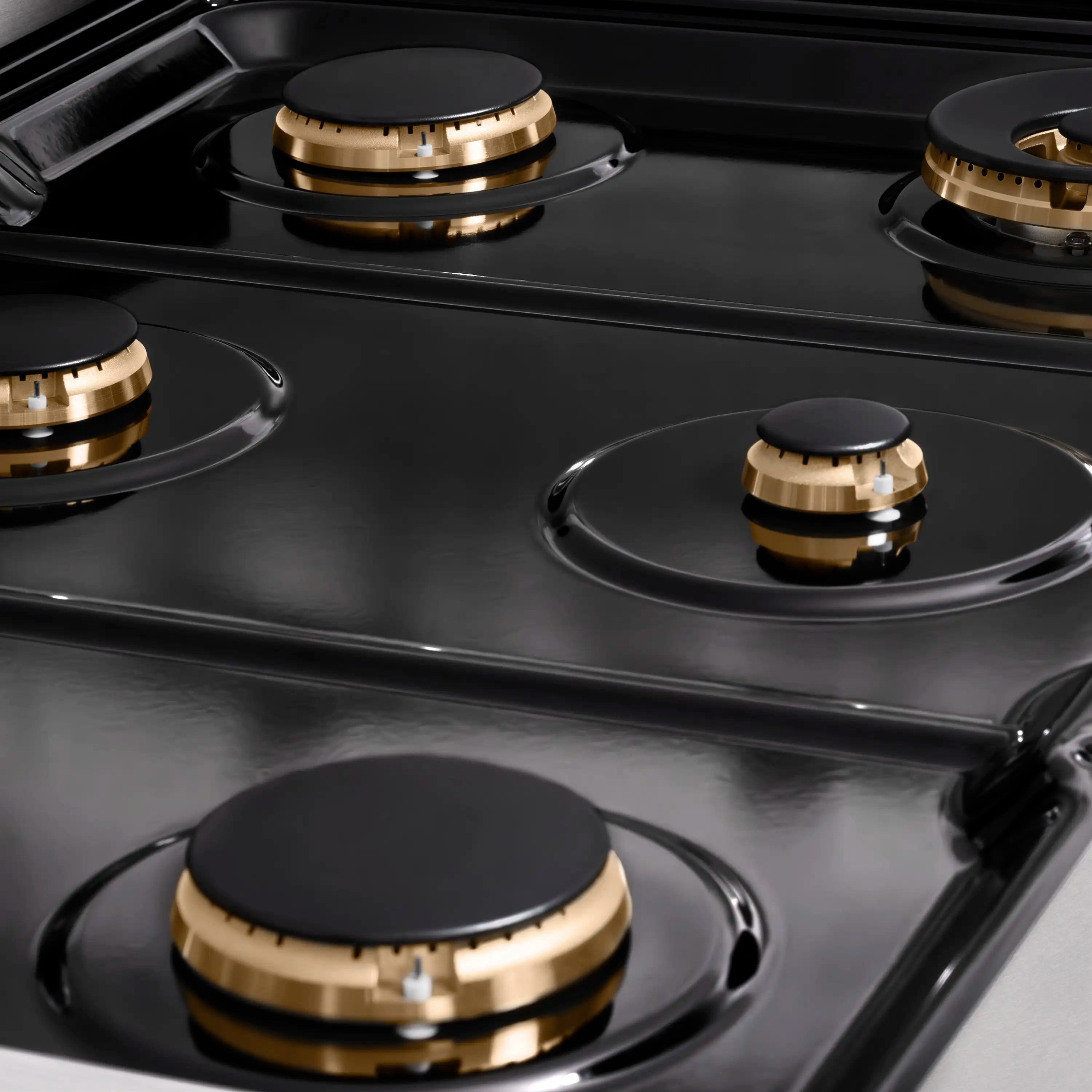 Black porcelain cooktop with cast burner head and champagne bronze trim