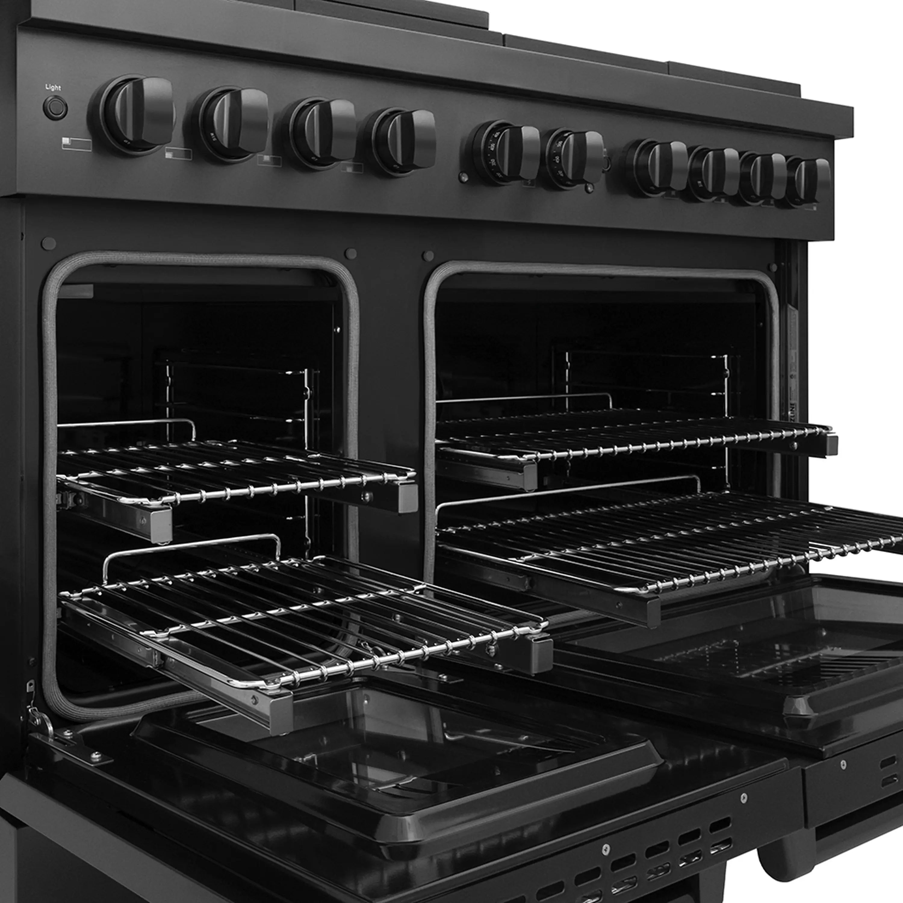 Black dual fuel range ovens with racks and broiler tray visible