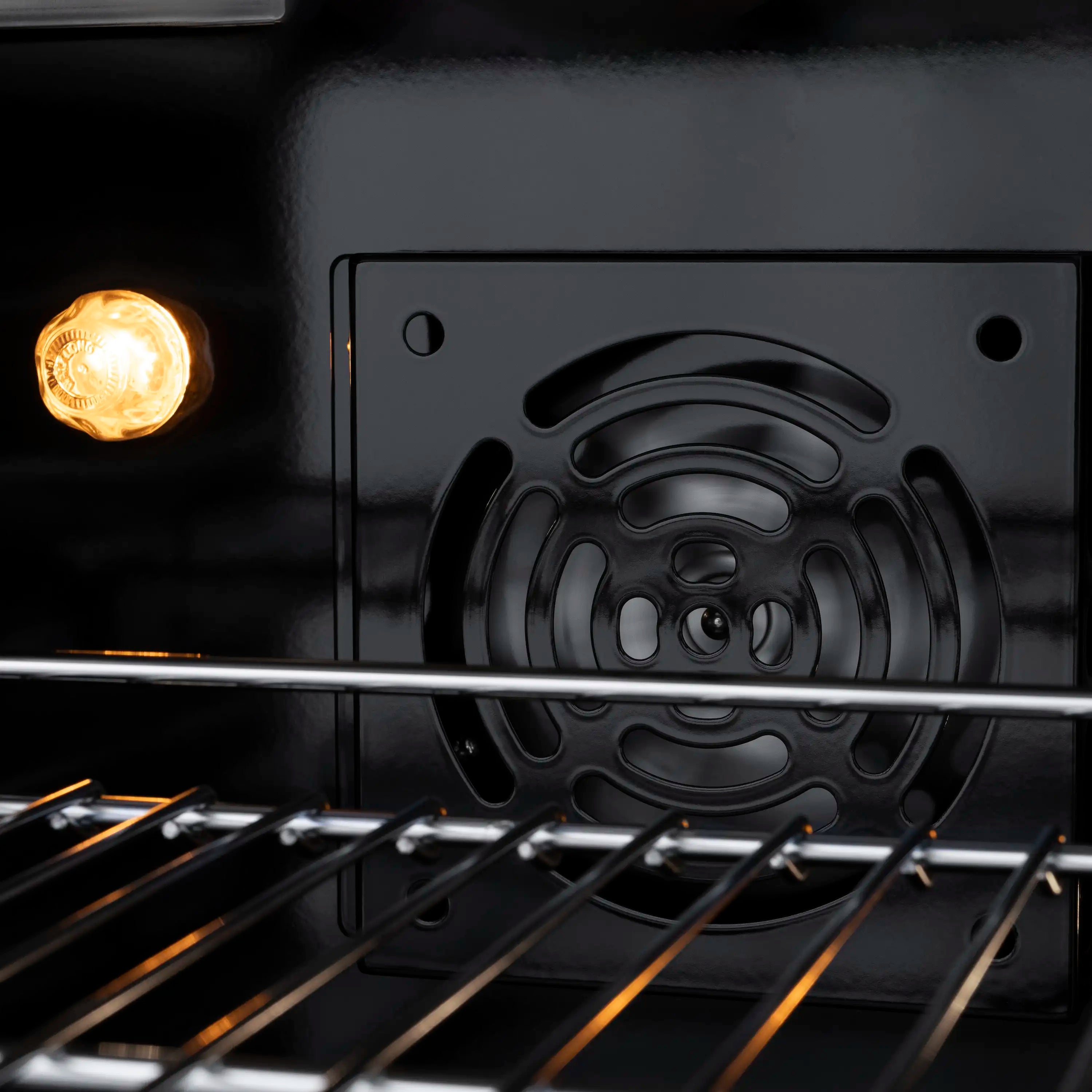 Black gas cooktop grates with burner cover and oven door control panel behind