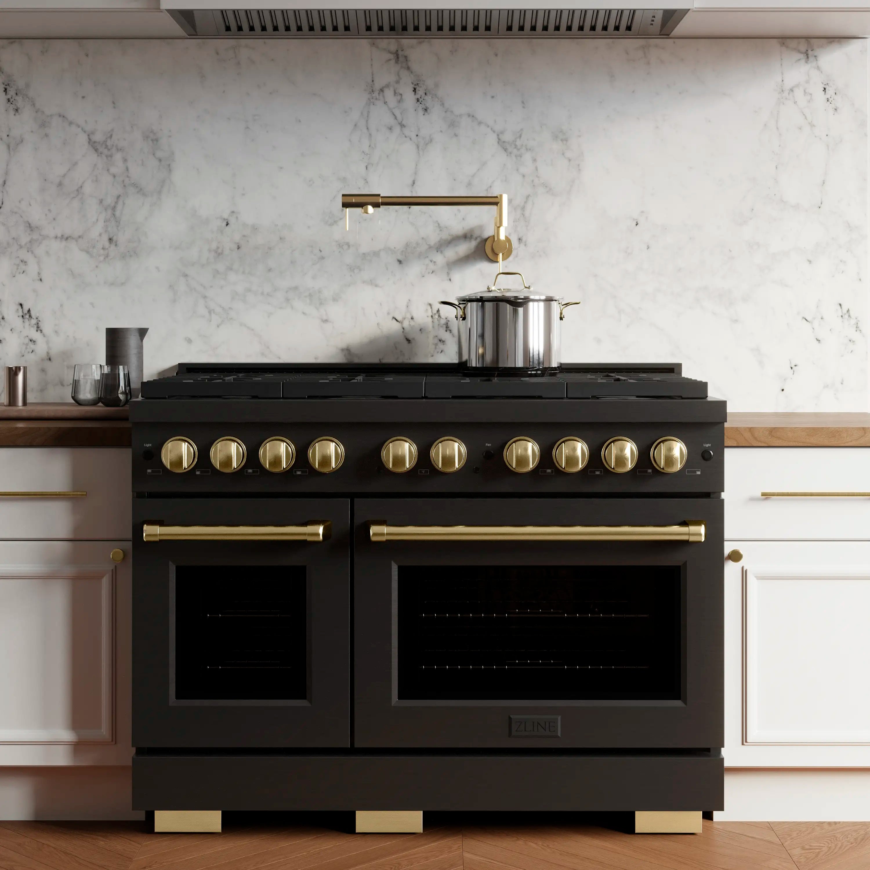 Black dual fuel range with gold knobs and long oven handles, double oven front