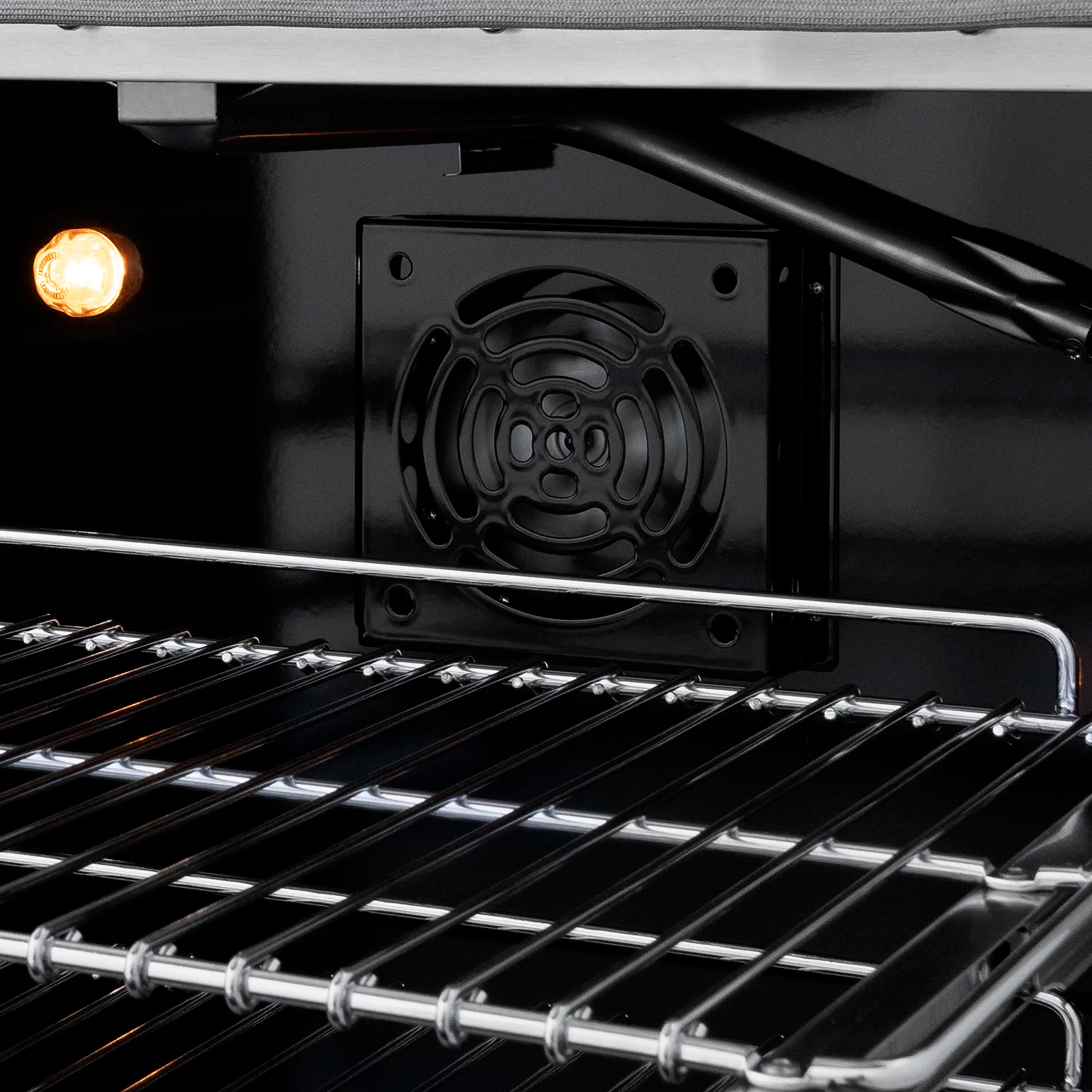Gas oven interior with racks and visible burner cover