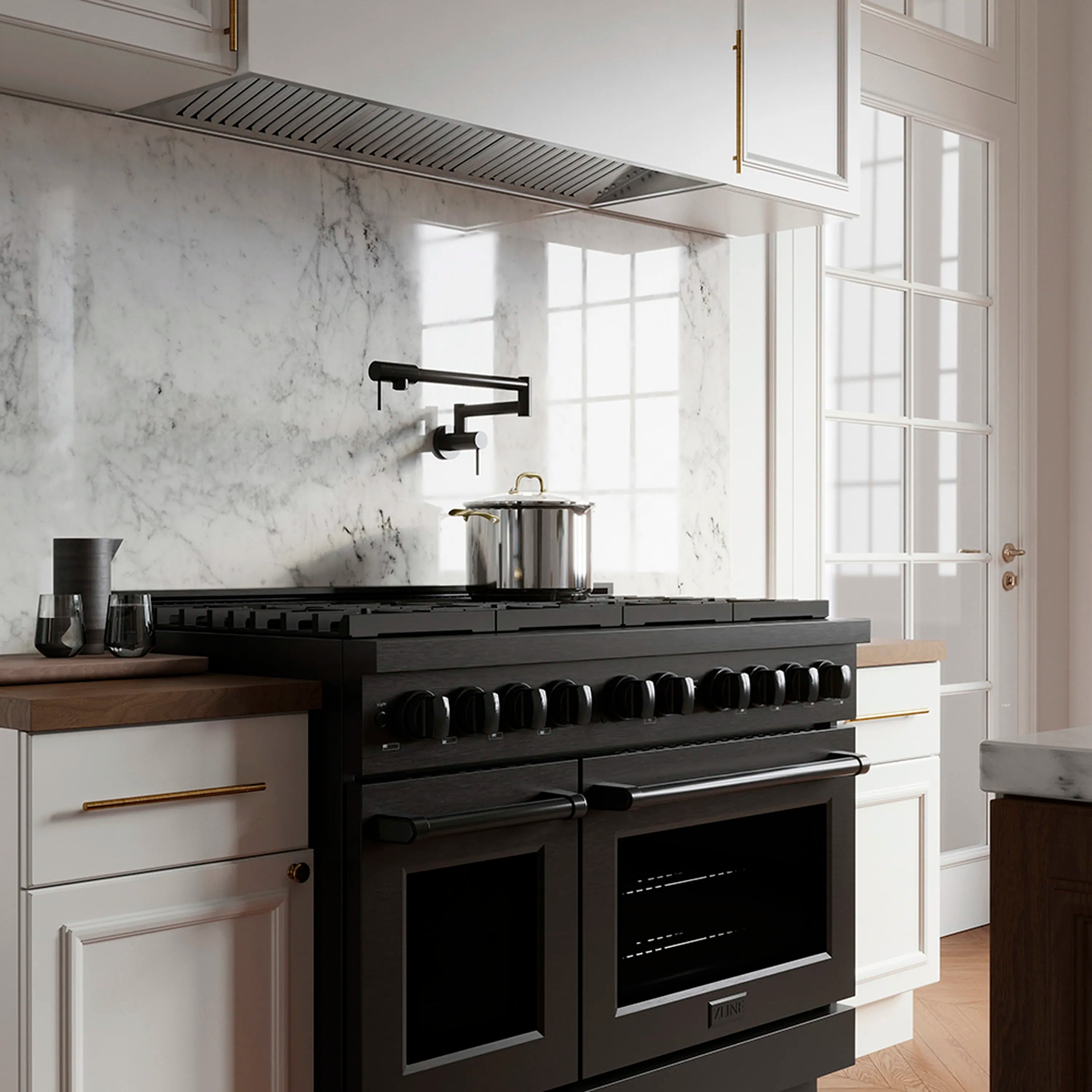 Black stainless dual-oven gas range in a kitchen with front burner knobs, side view.