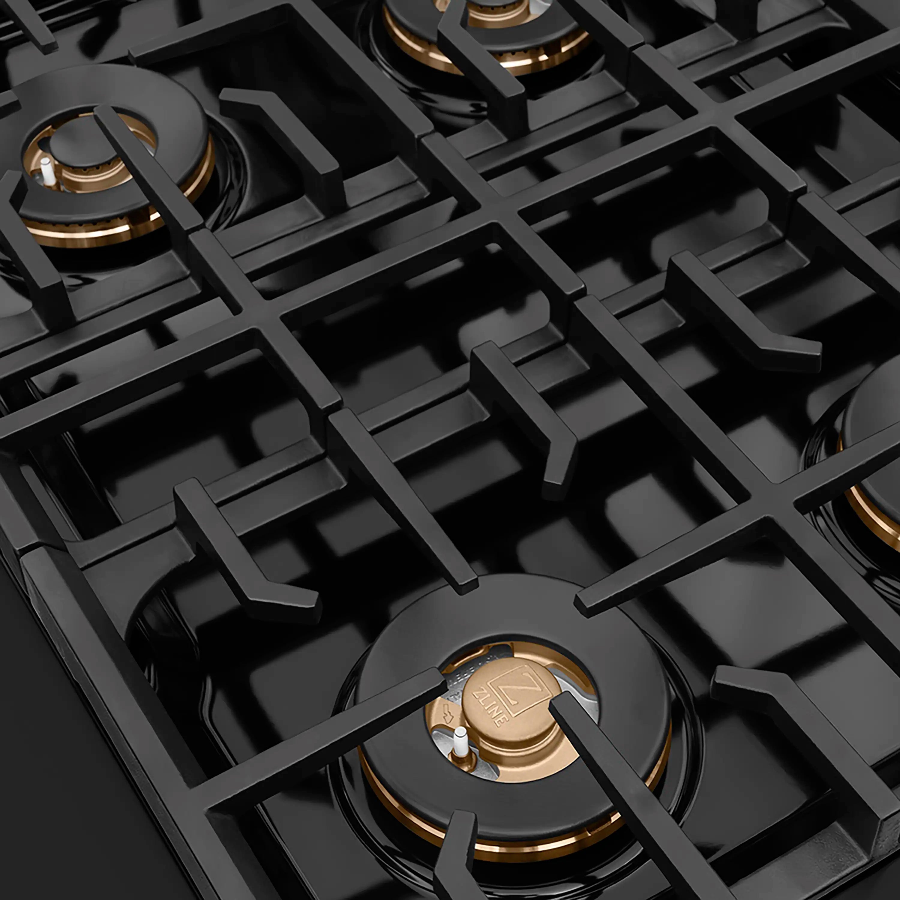 Gas cooktop grate with multiple burner openings and gold-accent burner caps