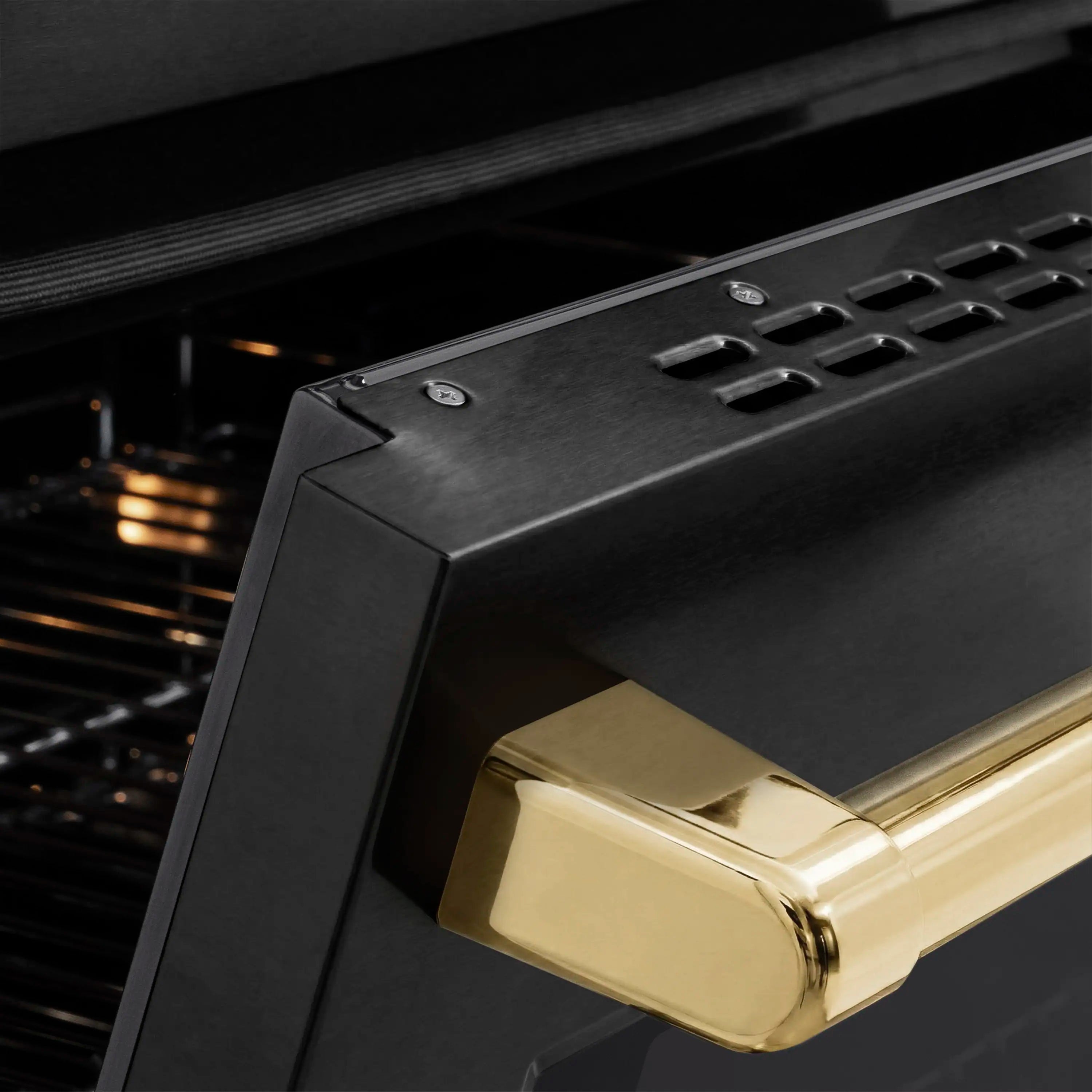 Polished gold oven handle on black stainless oven door