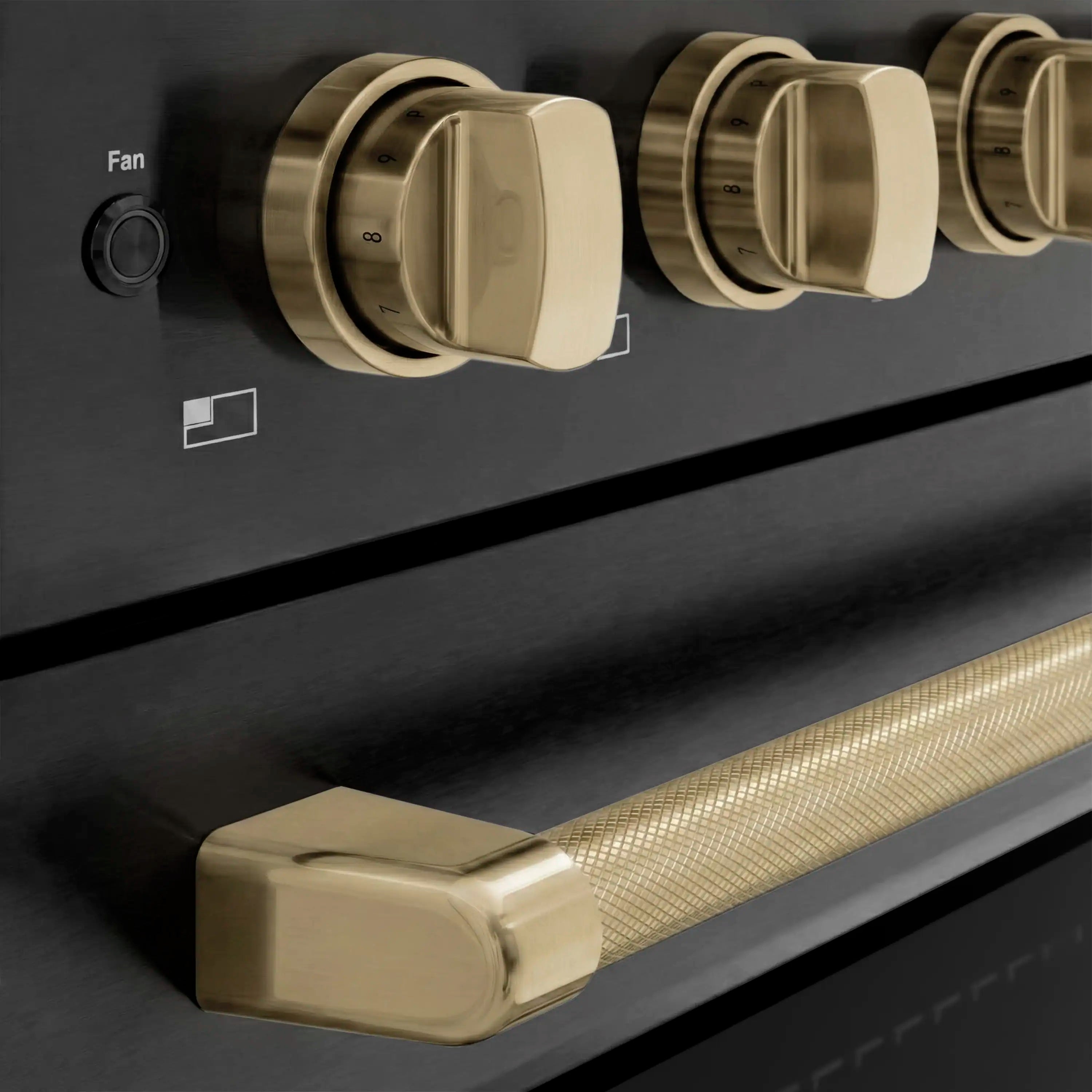 Champagne bronze control knobs on black stainless induction cooktop and handle