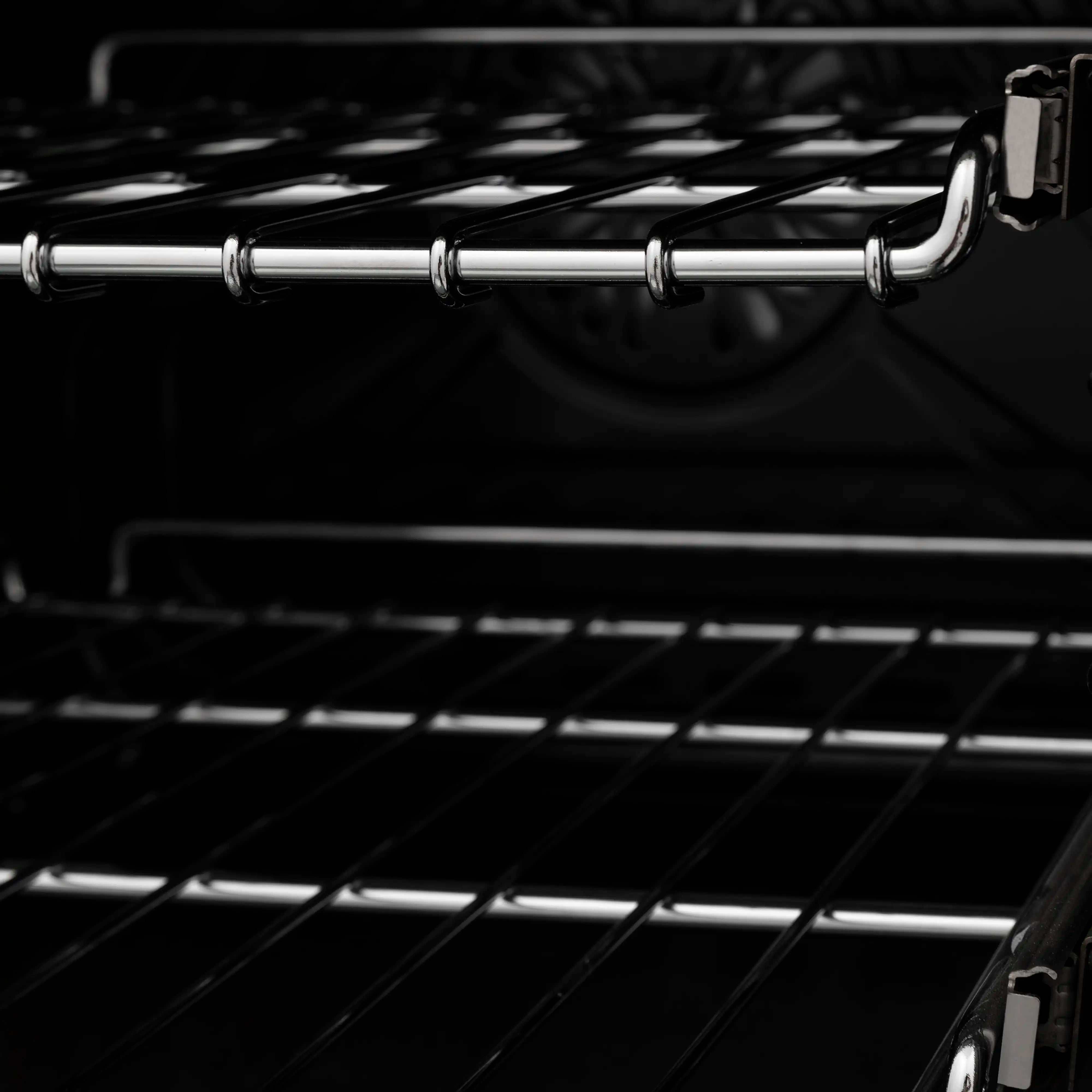 Dual fuel oven rack and broiler area with chrome warming rails