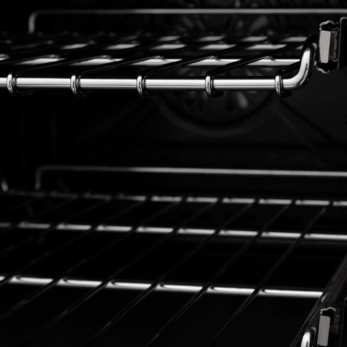 Black oven interior with wire rack and shiny chrome rails