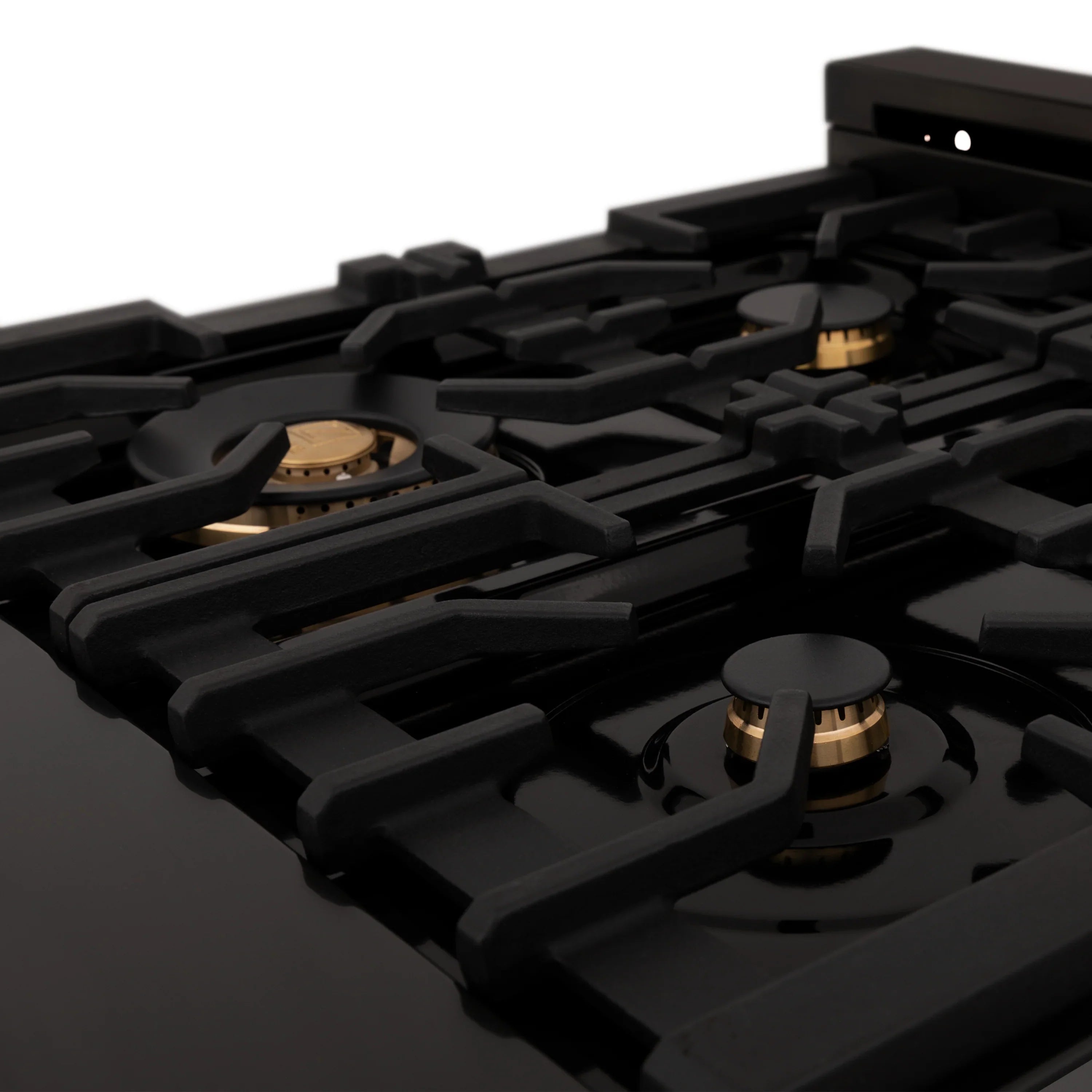 Close-up of black cast-iron grates and burner caps on a gas rangetop