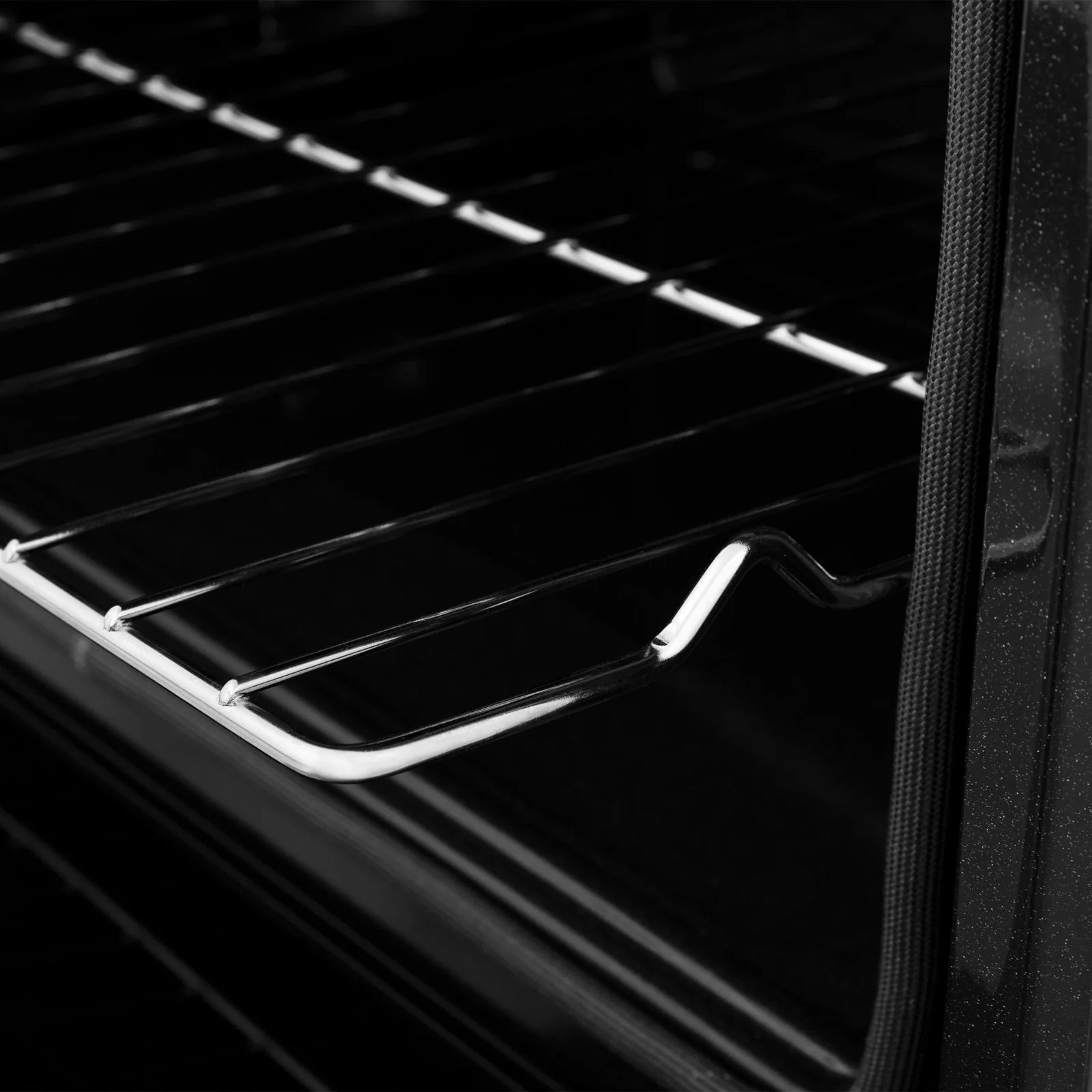 Black oven interior with wired rack and curved side guide rail
