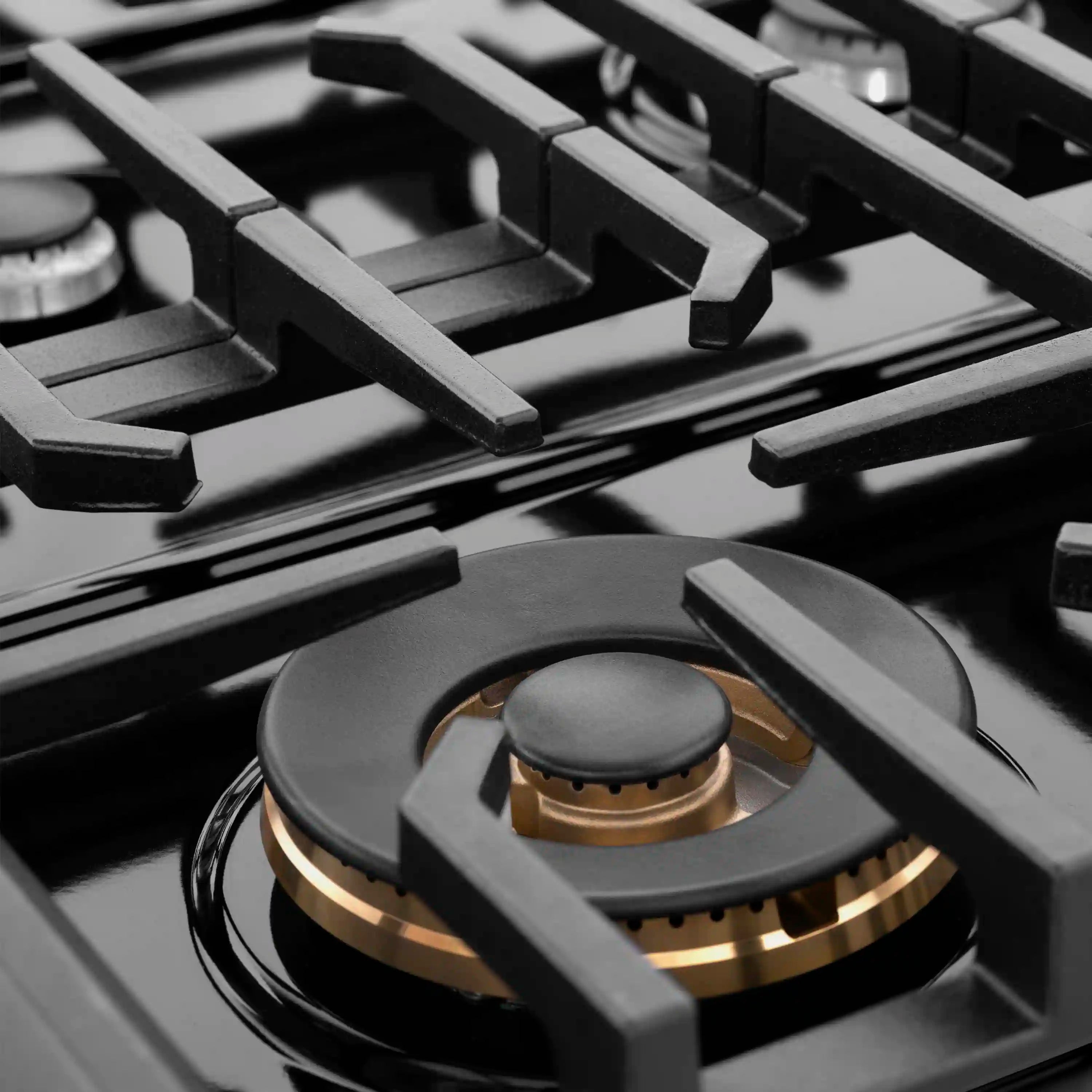 Dual-function gas burner with black burner cap and brass-colored ring