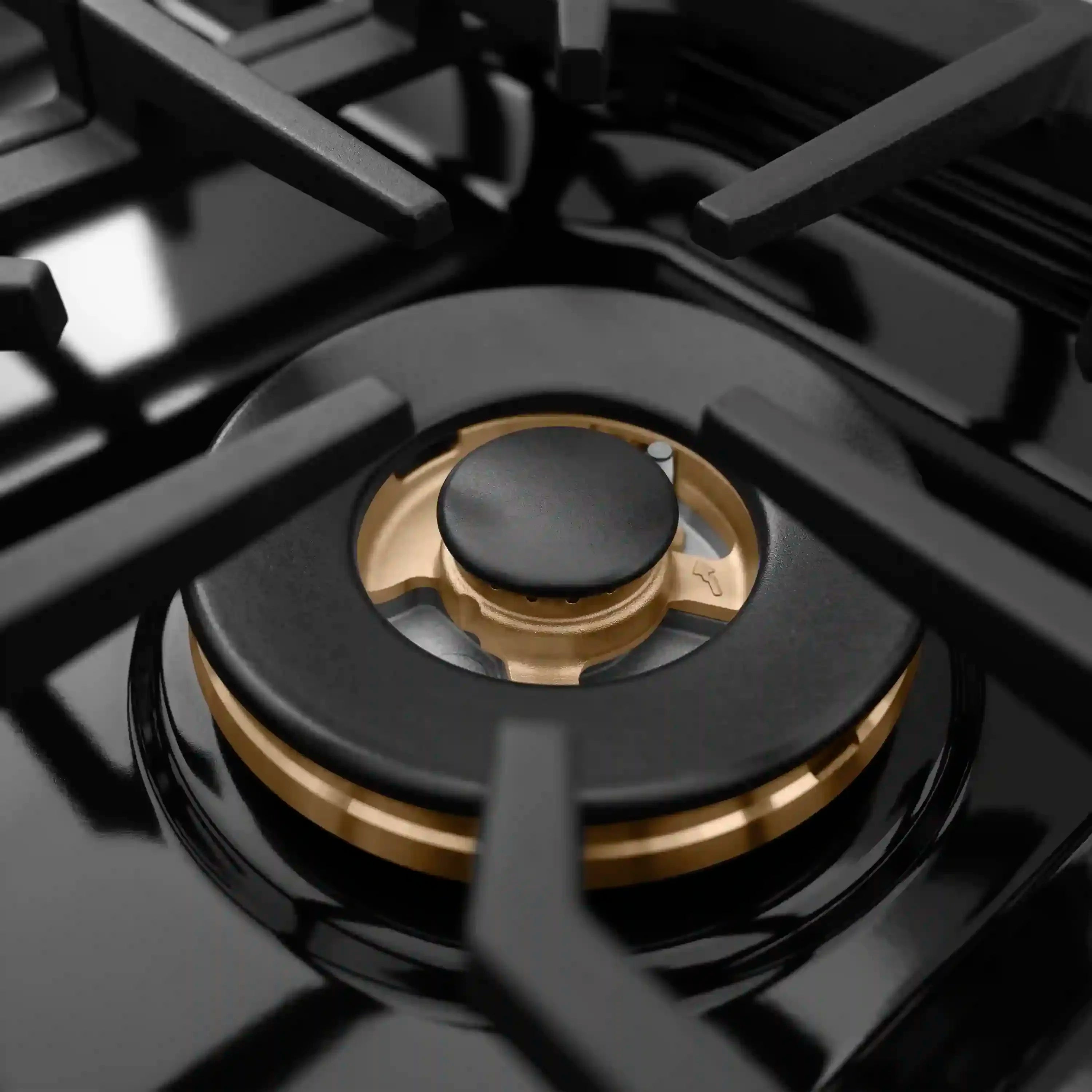 Single black gas burner with gold accent ring and black burner cap