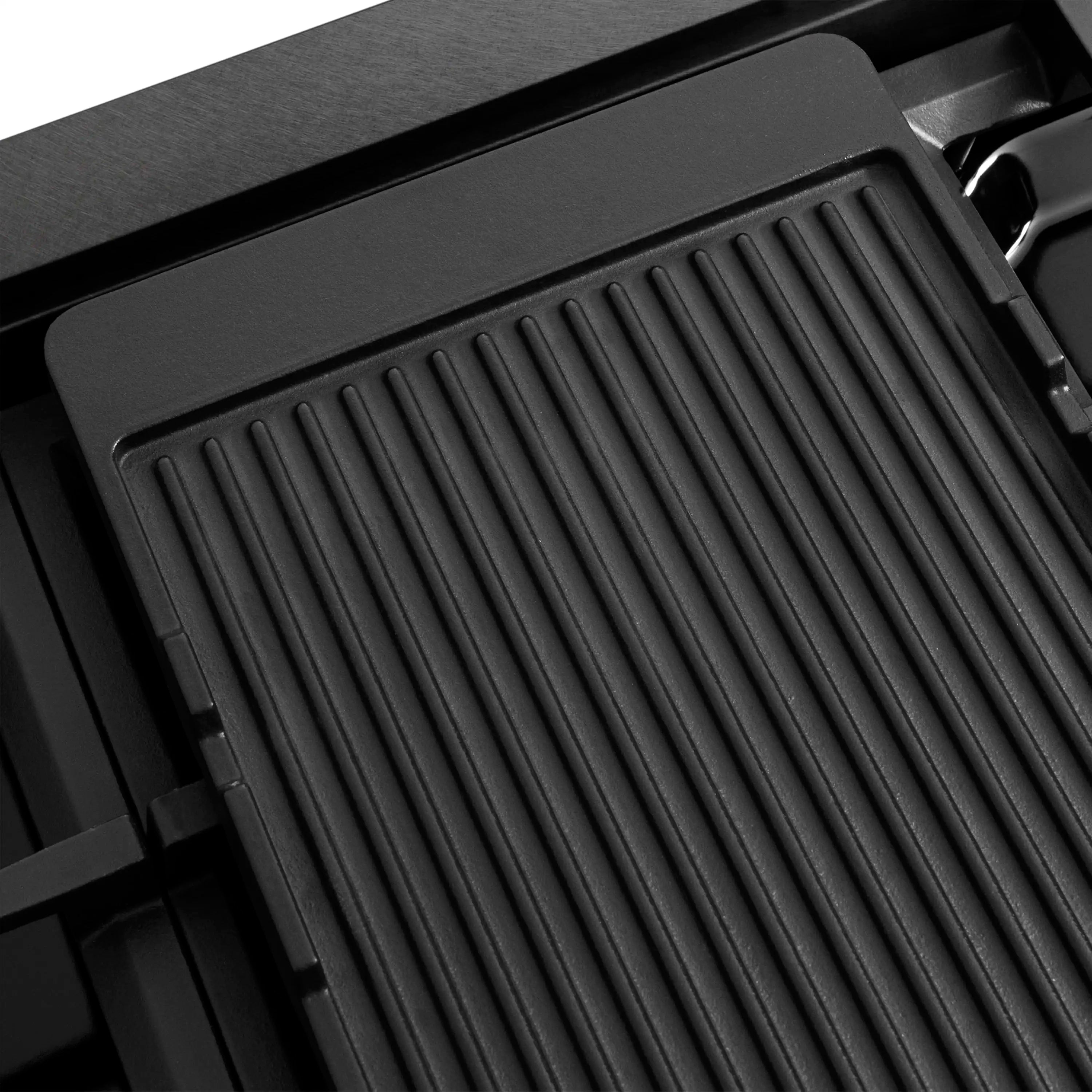 Black griddle insert with ridged cooking surface and surrounding cooktop frame