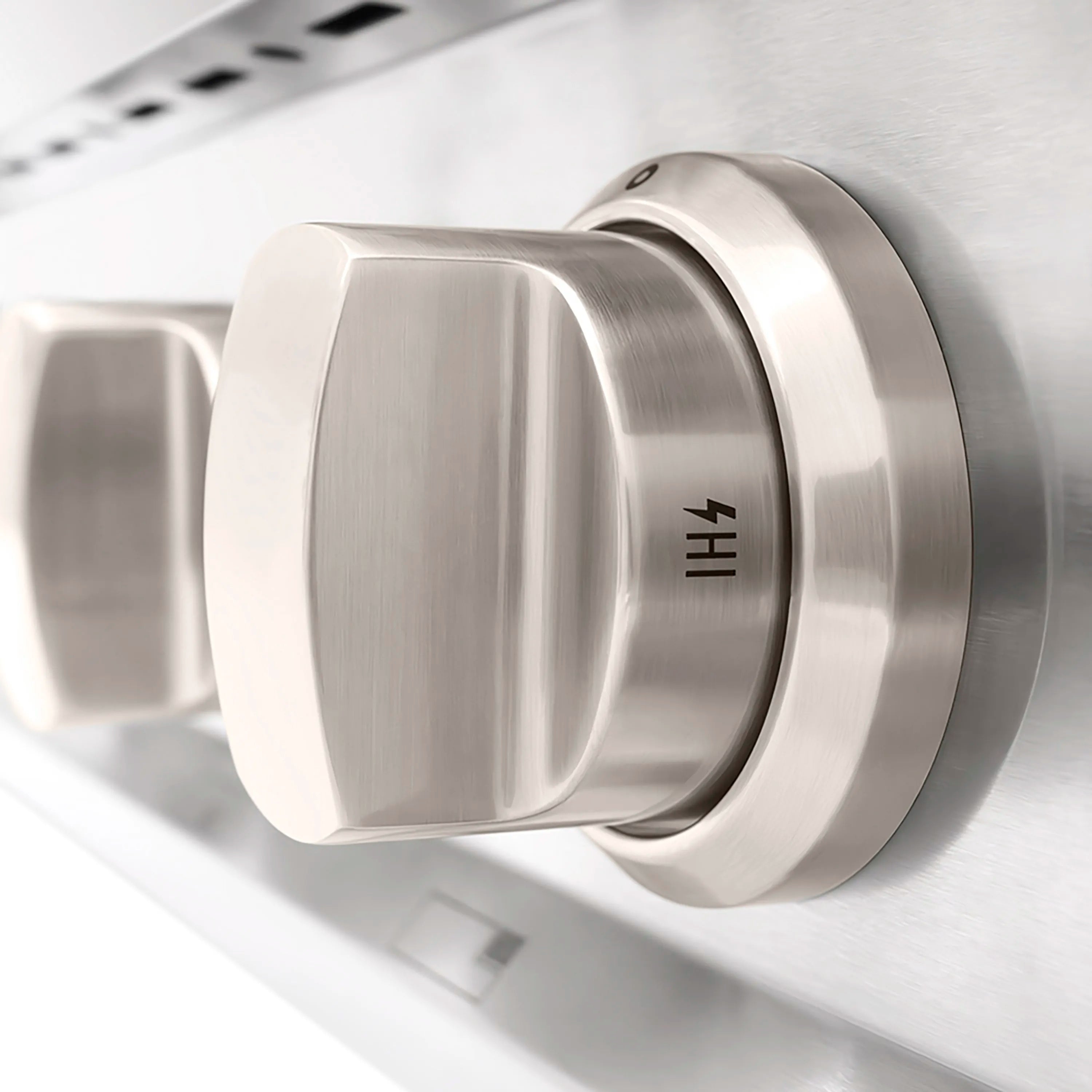 Stainless gas cooktop control knob in close-up on brushed metal surface