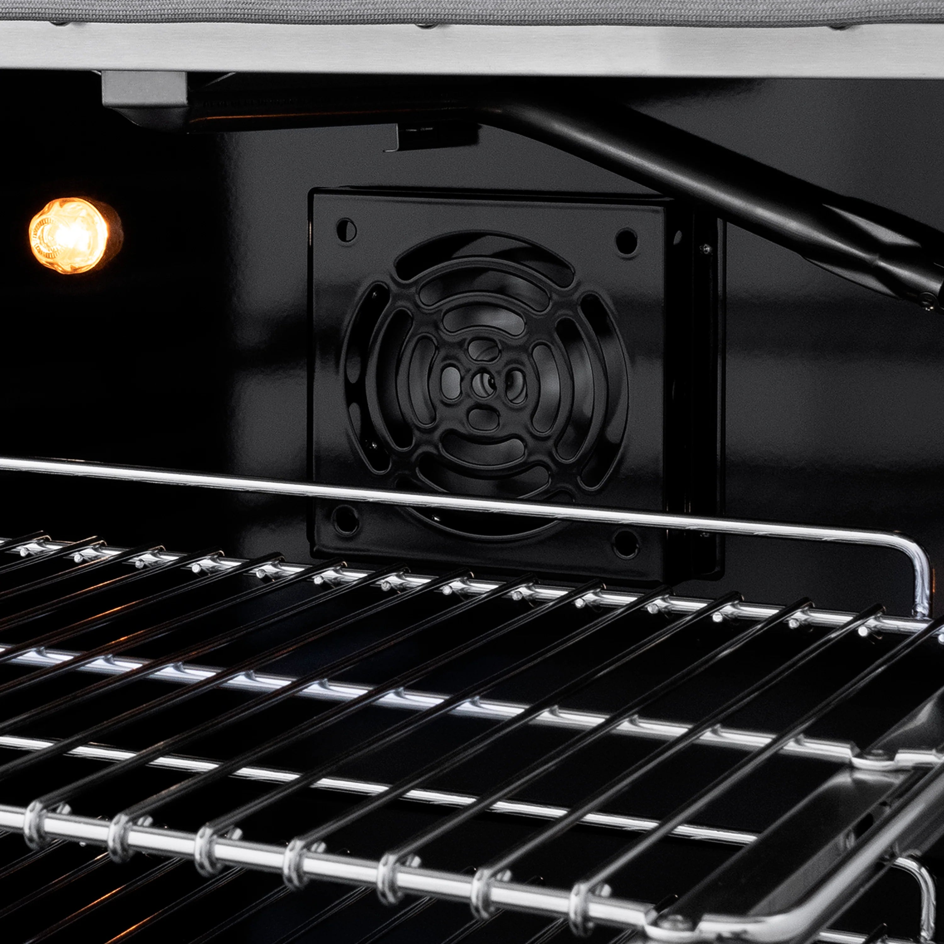 Gas oven interior showing burner cover area and wire rack surface