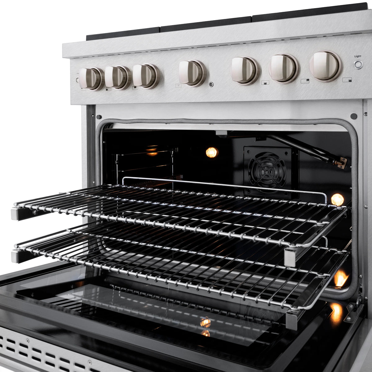 Gas oven door open showing racks and lit interior heating elements