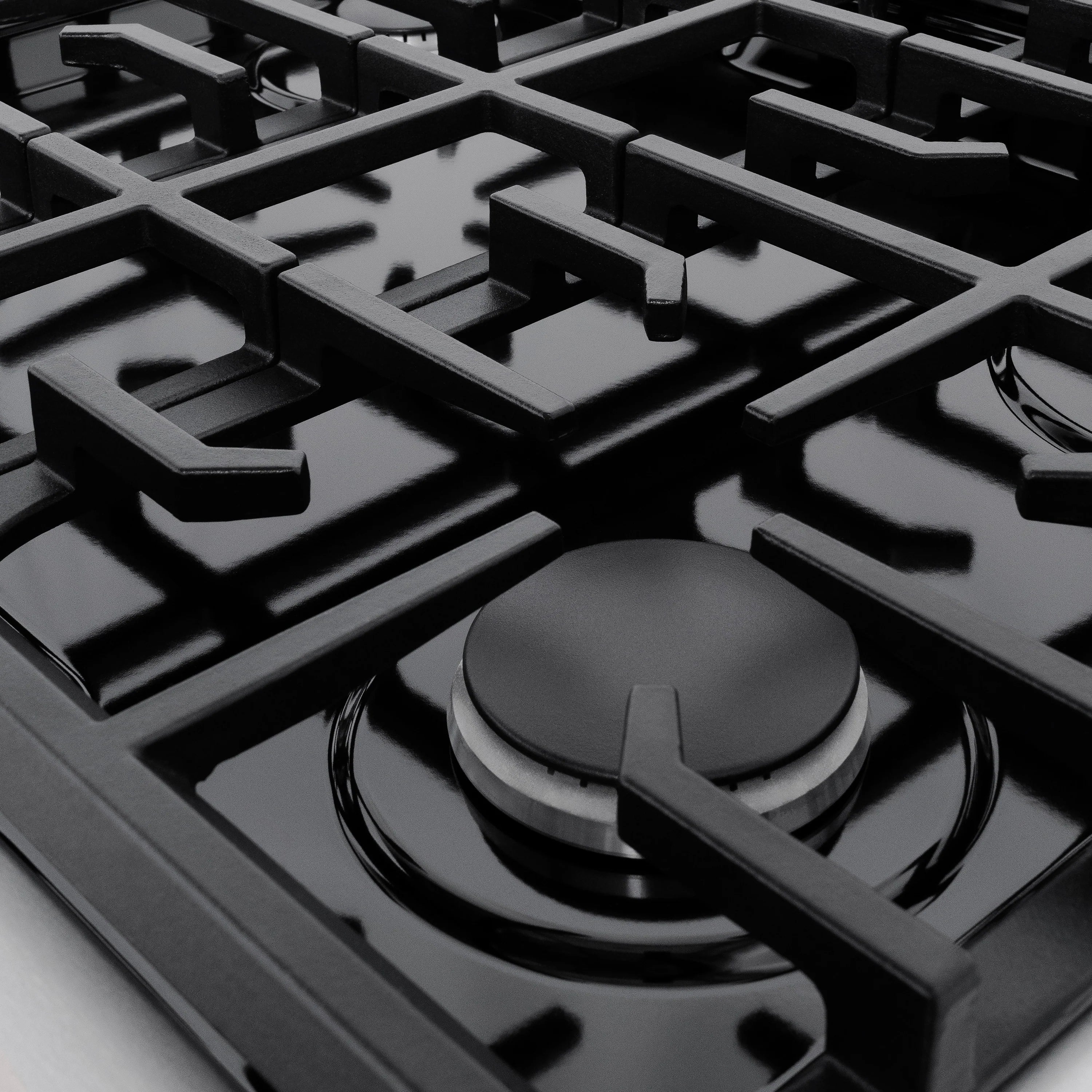 Black burner cap on a stainless steel gas cooktop grate