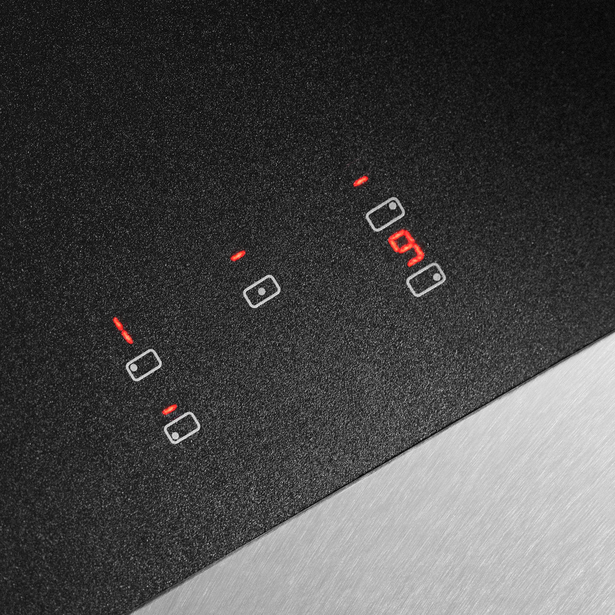 Black induction cooktop with touch control icons and red indicator lights