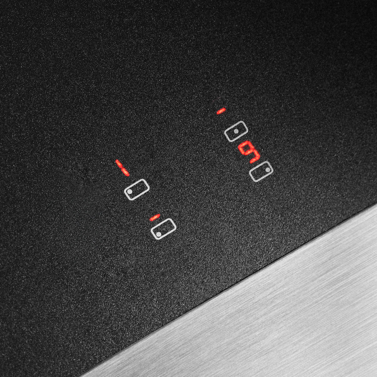 Black glass induction cooktop with illuminated heating indicators and touch control icons