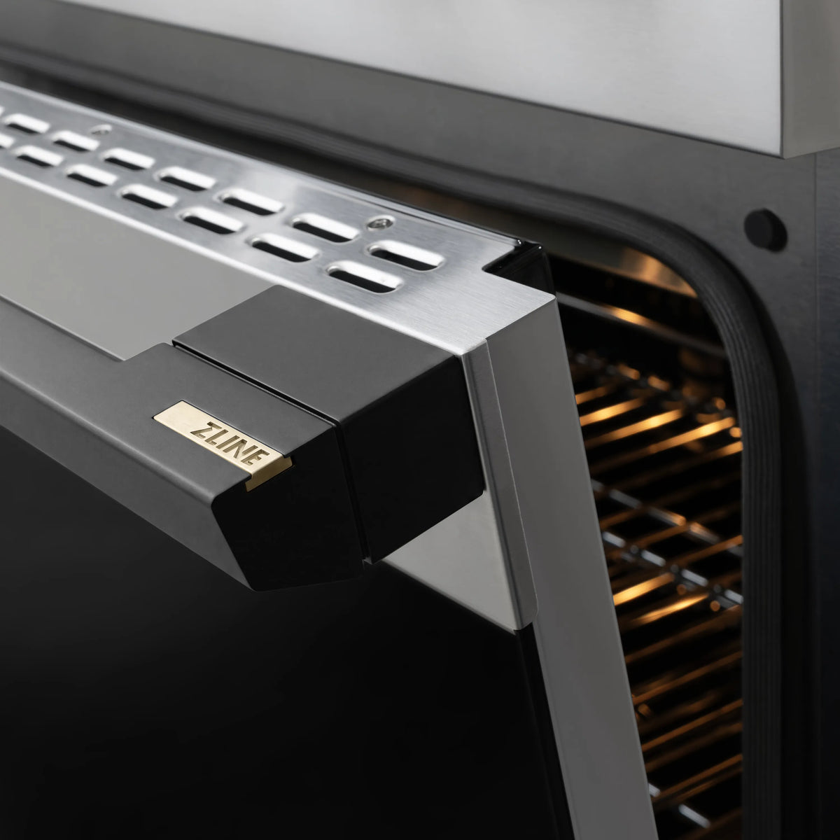 ZLINE-branded stainless range control housing on oven door edge with matte black trim