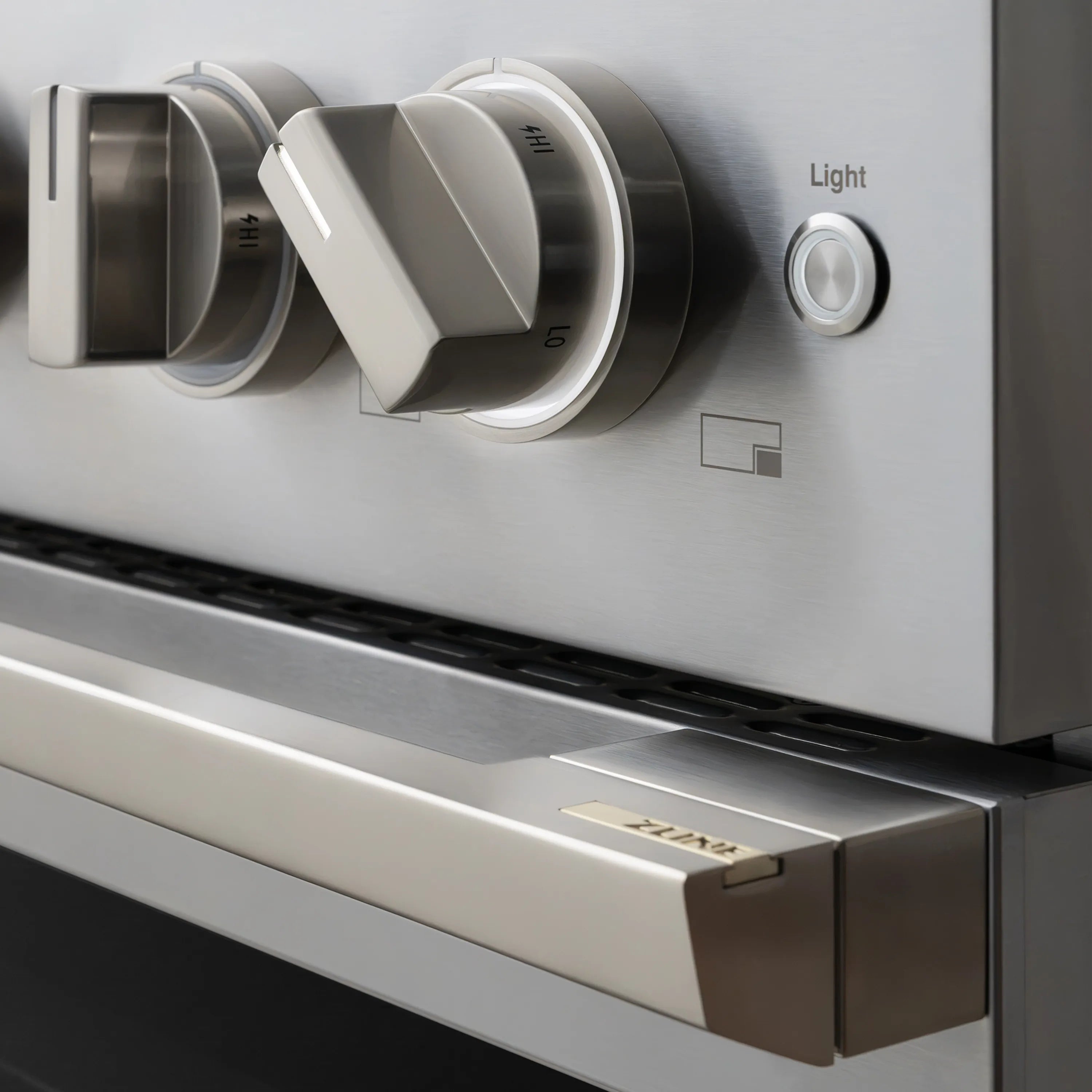 Stainless gas range control knob and oven light switch on front panel