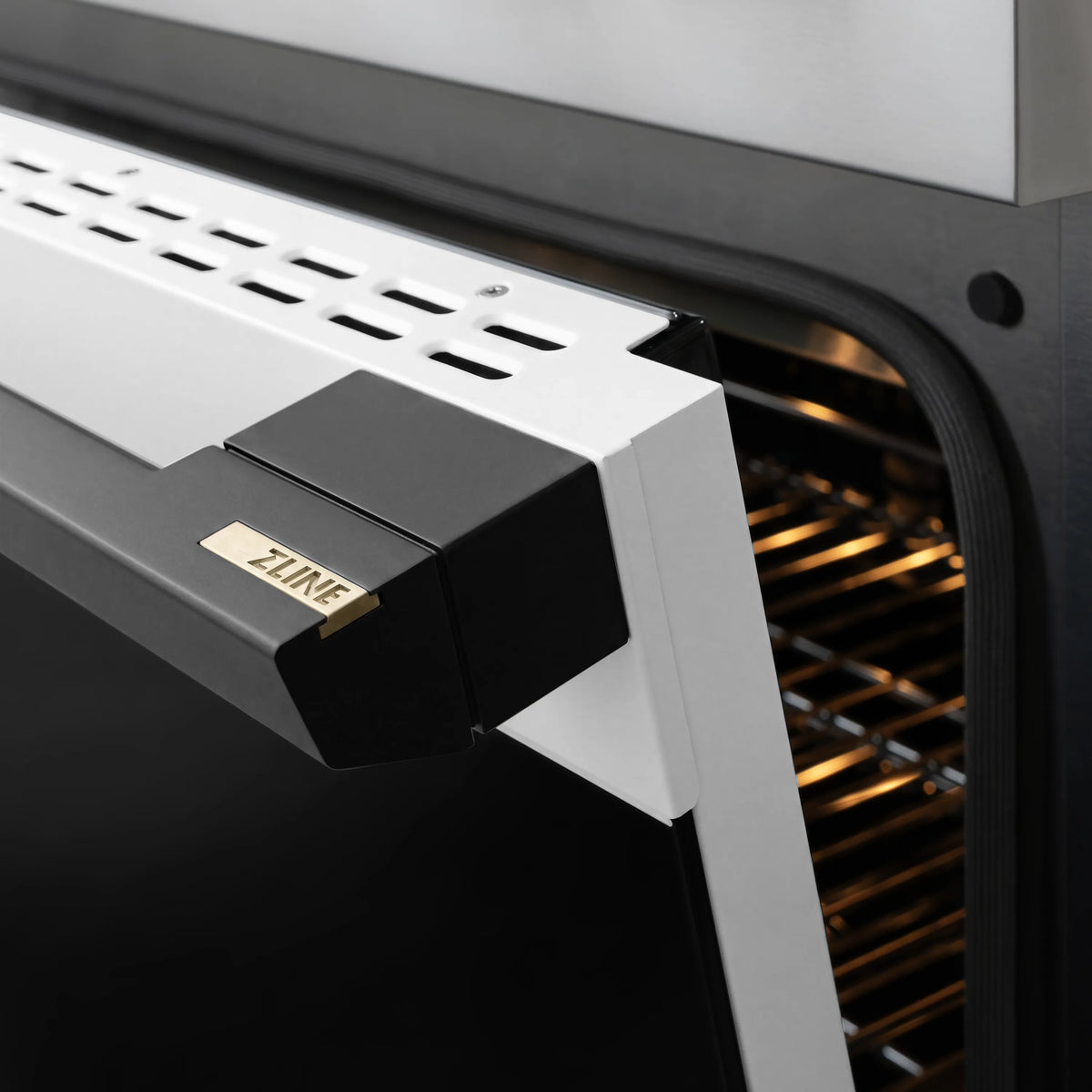 Open gas range door with black handle and ZLINE emblem