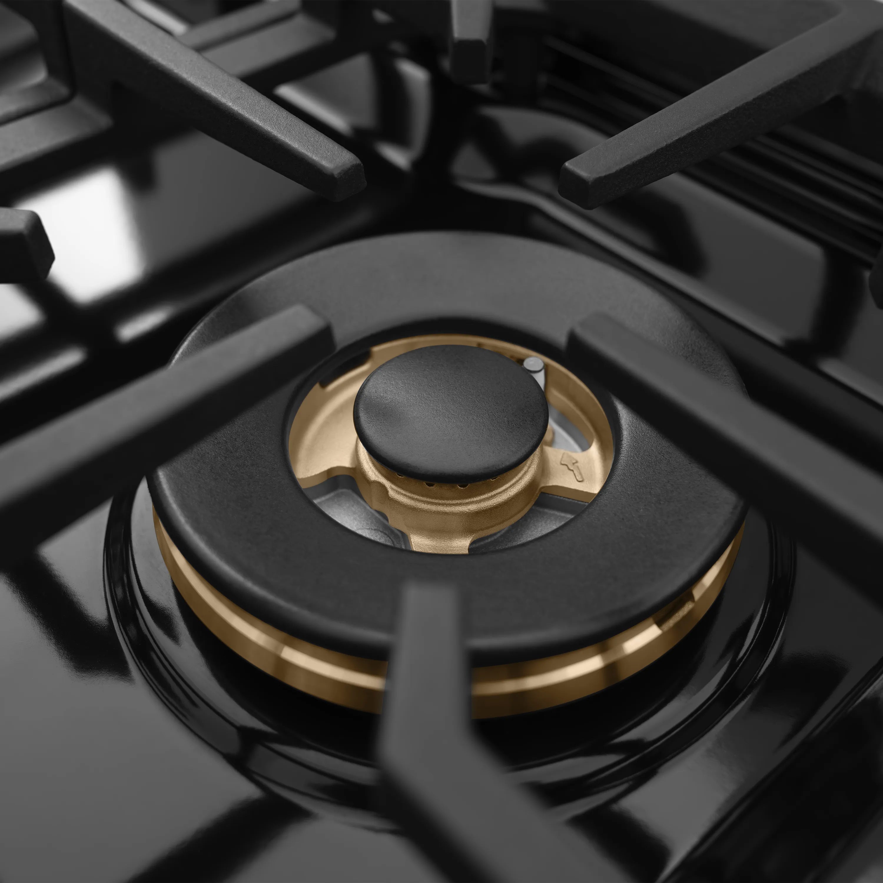 Single gas burner with black cap and brass ring centered on a cast-iron style grate.
