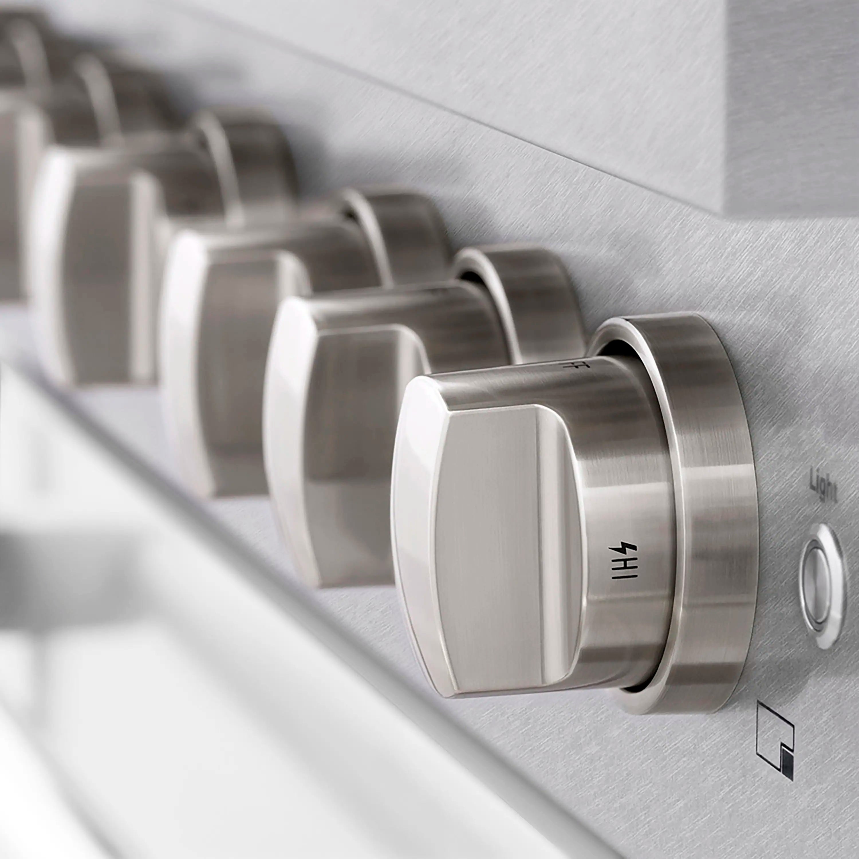 Stainless steel control knob row with brushed satin finish