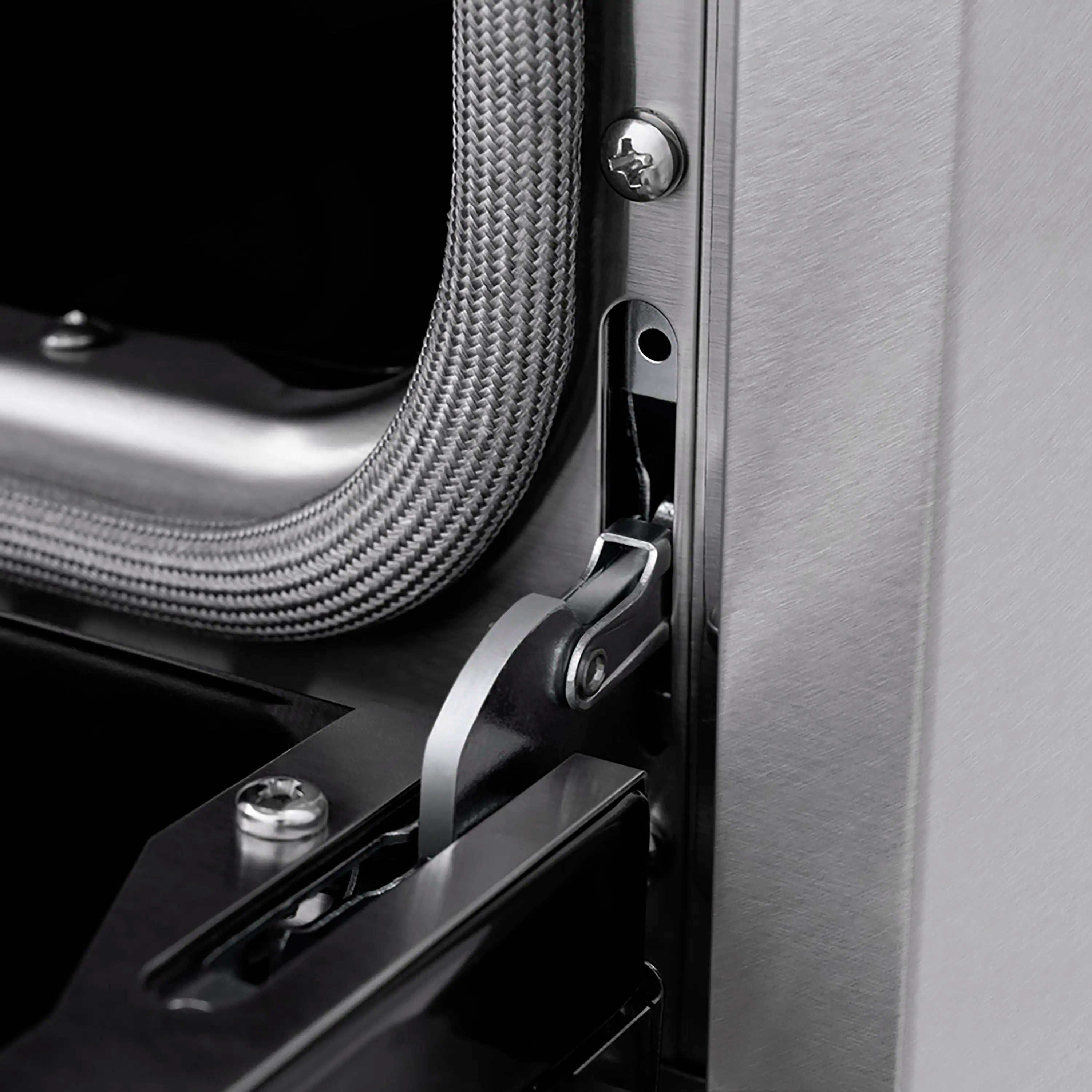 Stainless oven door handle with flexible gas line and latch hardware detail