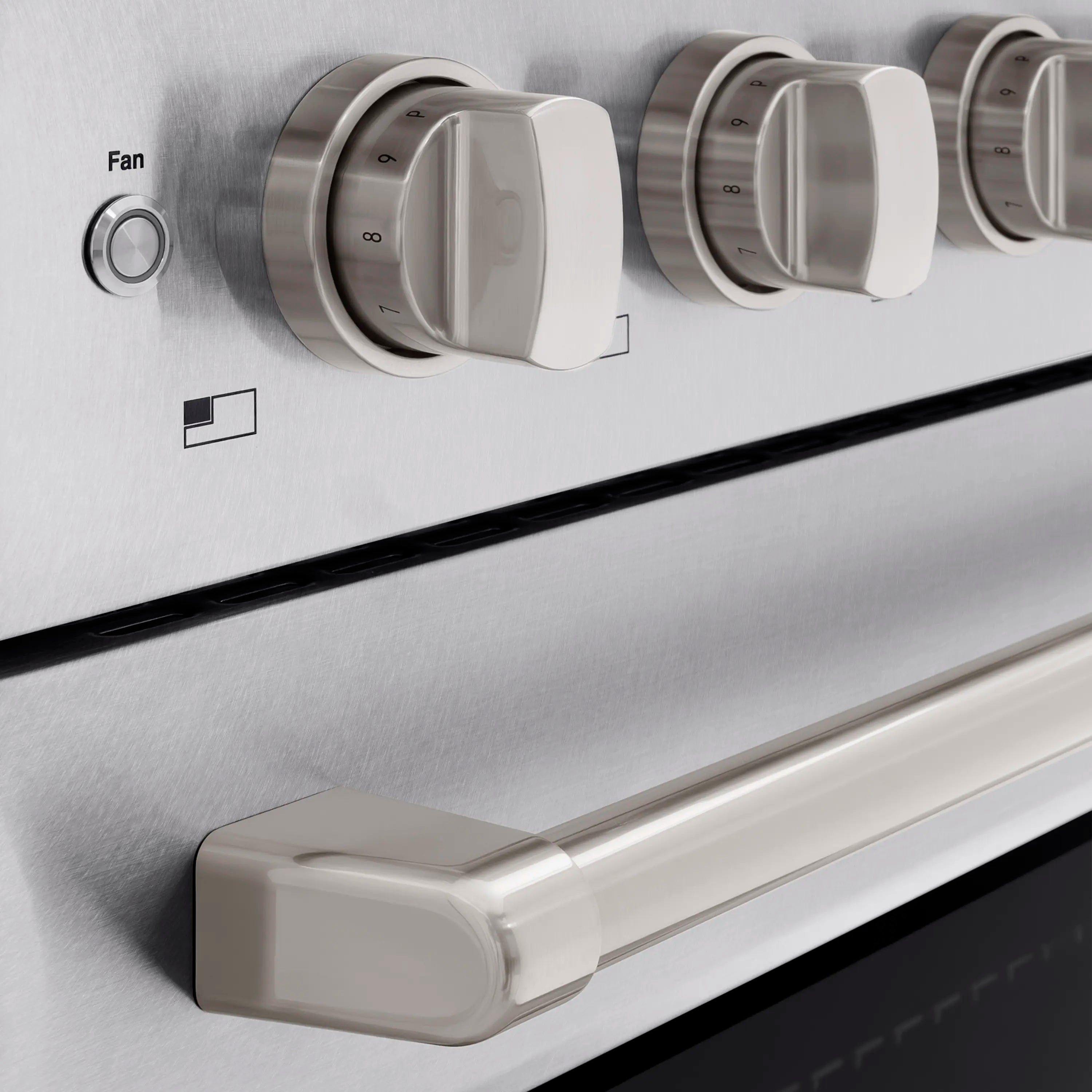Satin stainless induction range front with knob controls and oven handle, close-up.