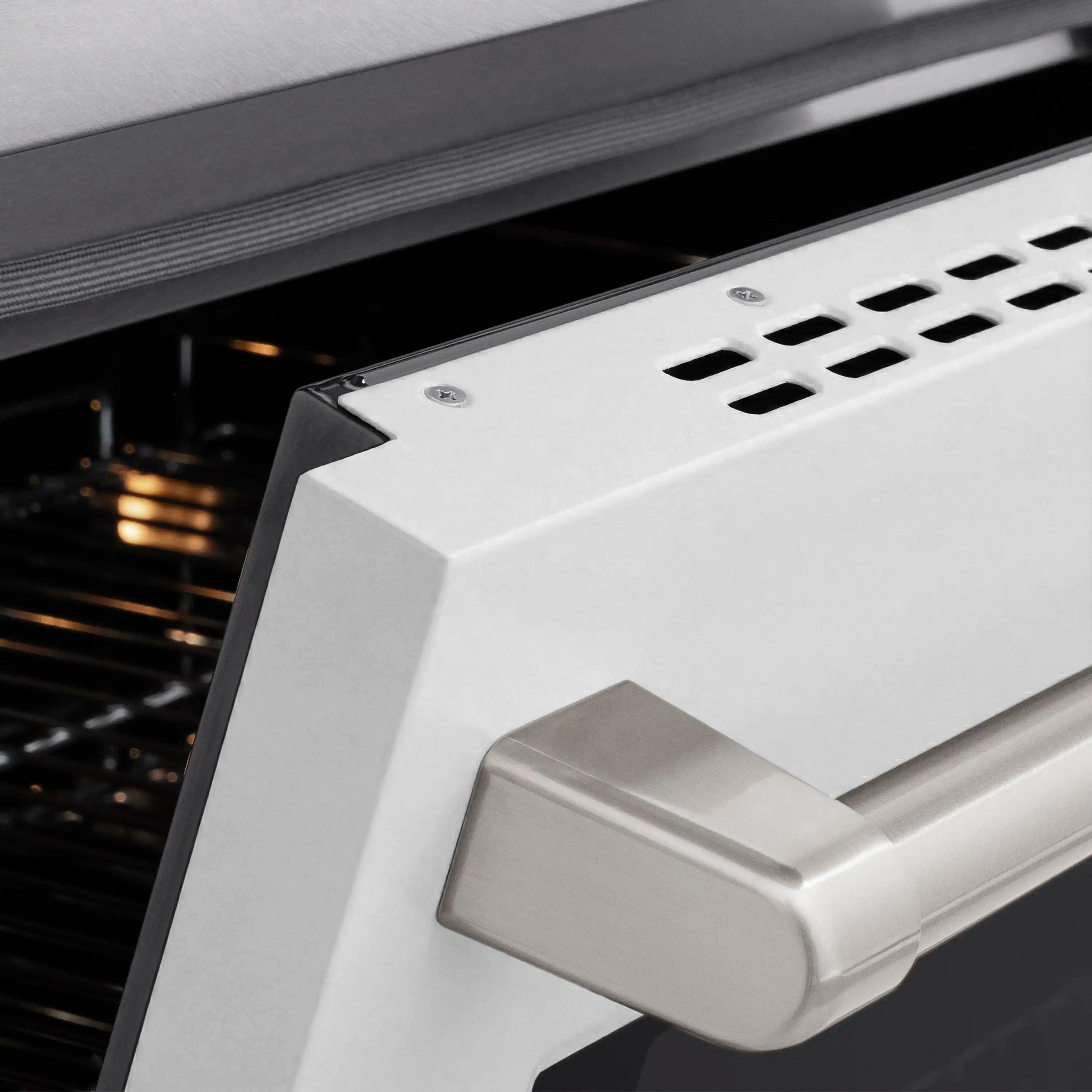 Induction cooktop control housing detail with vented panel and satin stainless finish