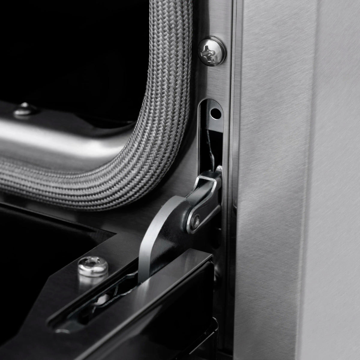 Induction range side panel with matte black handle hardware and connected hose
