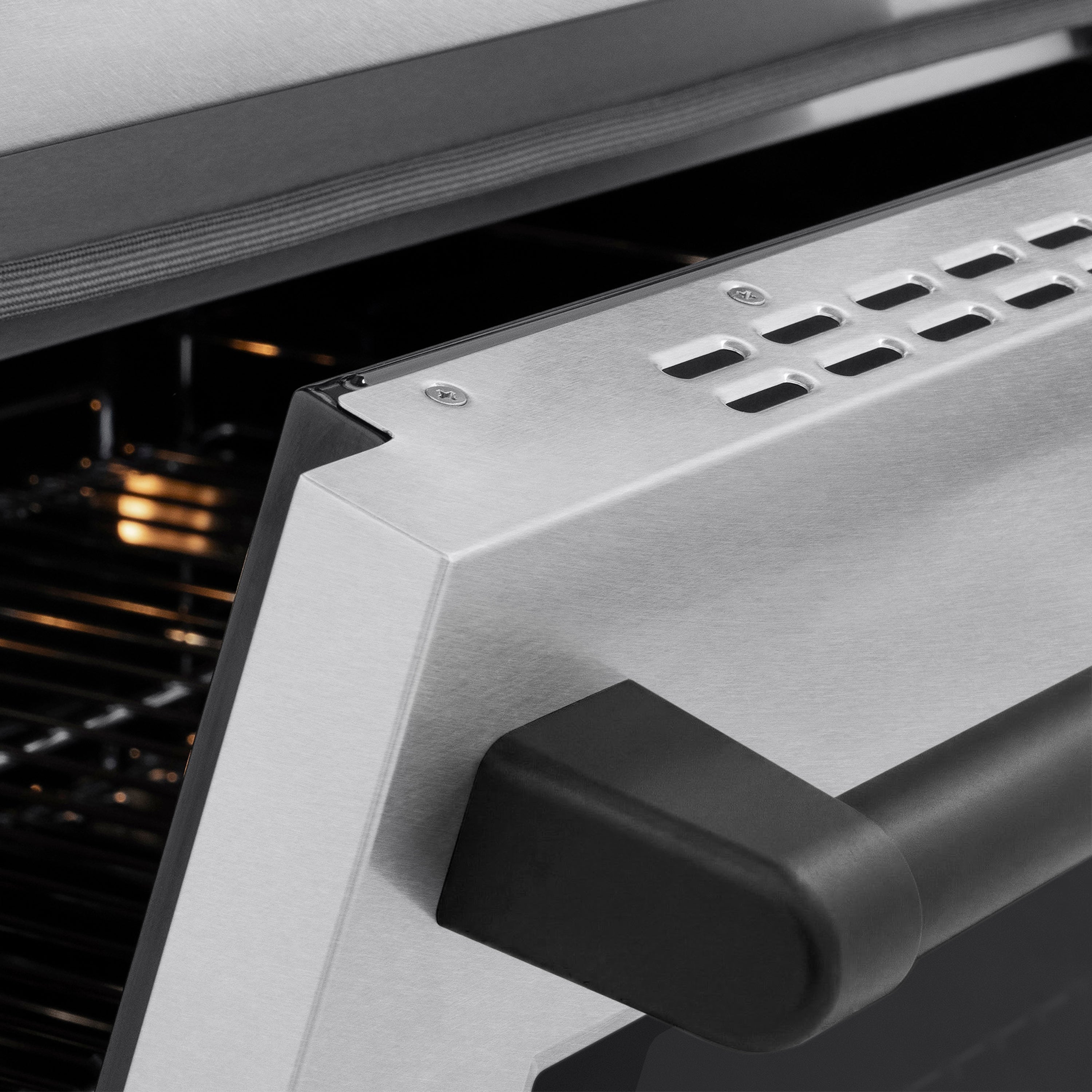 Matte black oven handle on satin stainless front panel