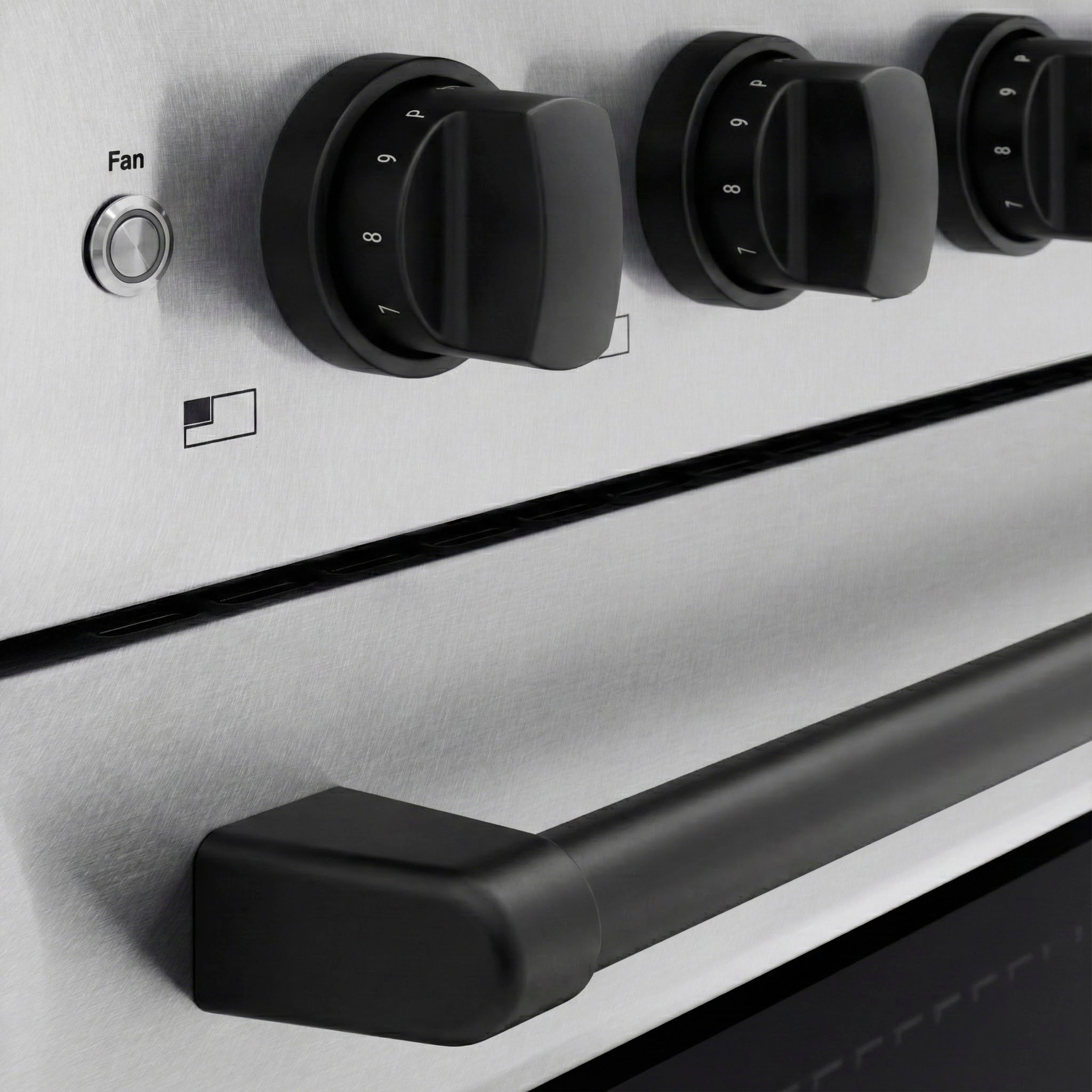 Black induction control knobs on satin stainless panel with fan label
