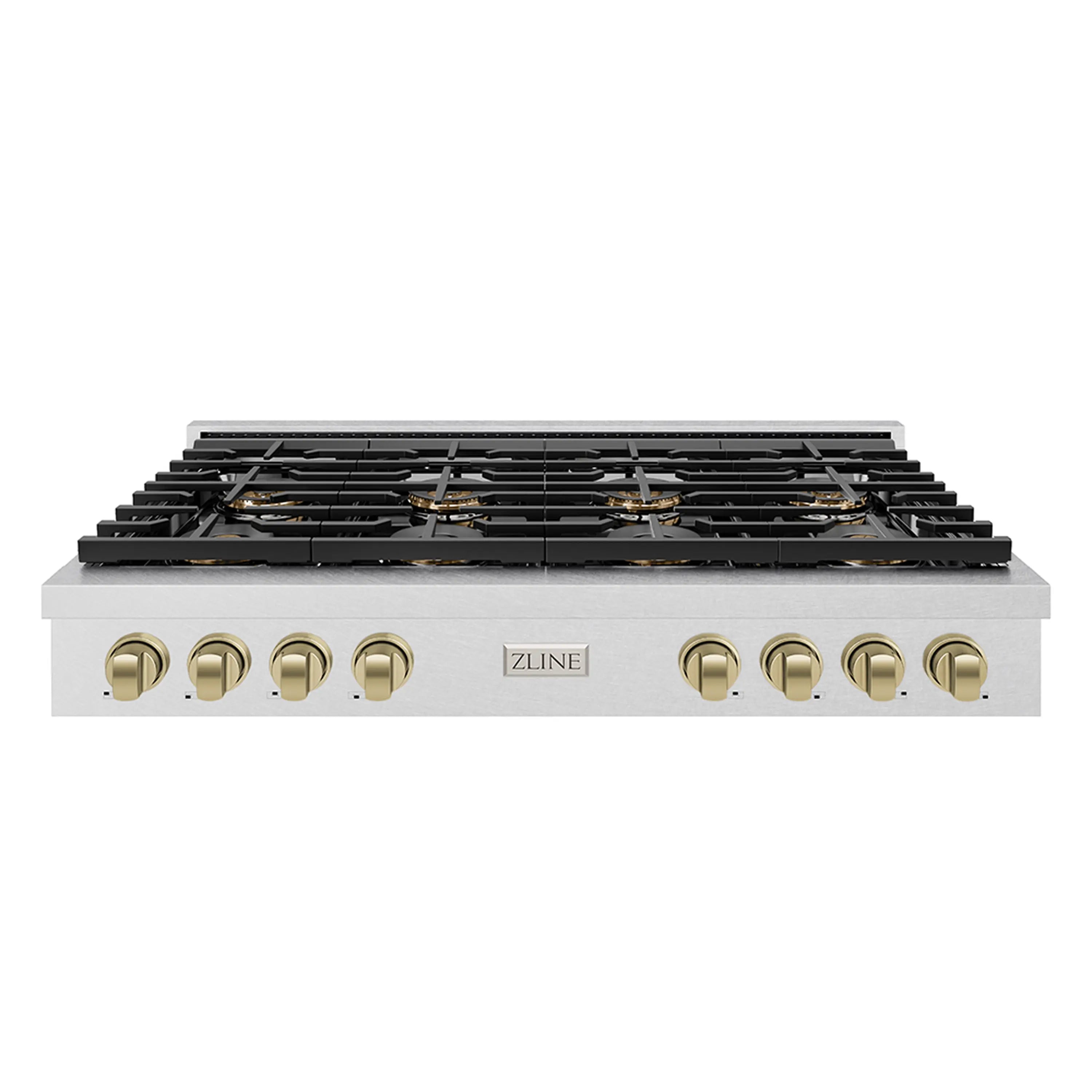 Stainless steel gas cooktop with black grates and champagne-toned control knobs