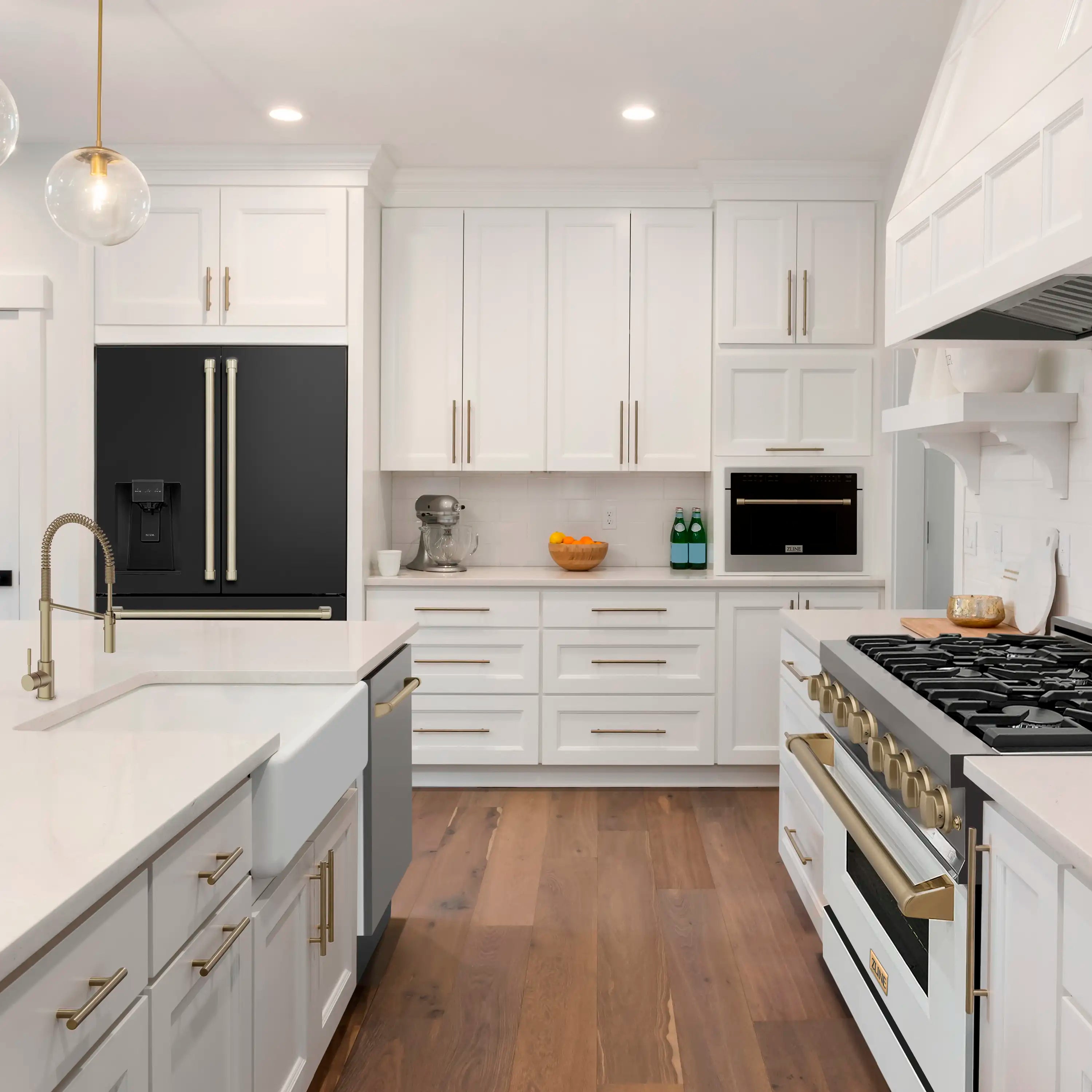 Black stainless range and French door refrigerator in a white kitchen with gold accents