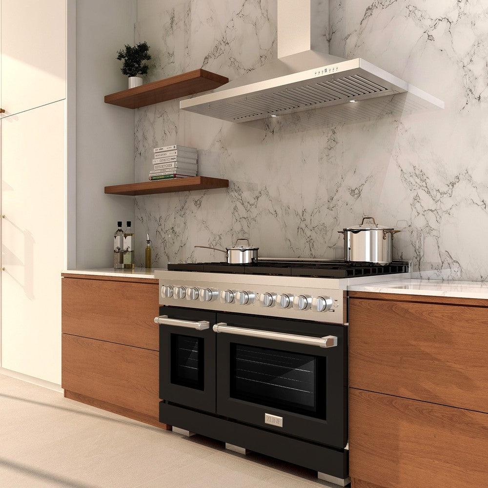 Stainless gas range with black double oven doors in a modern kitchen setting