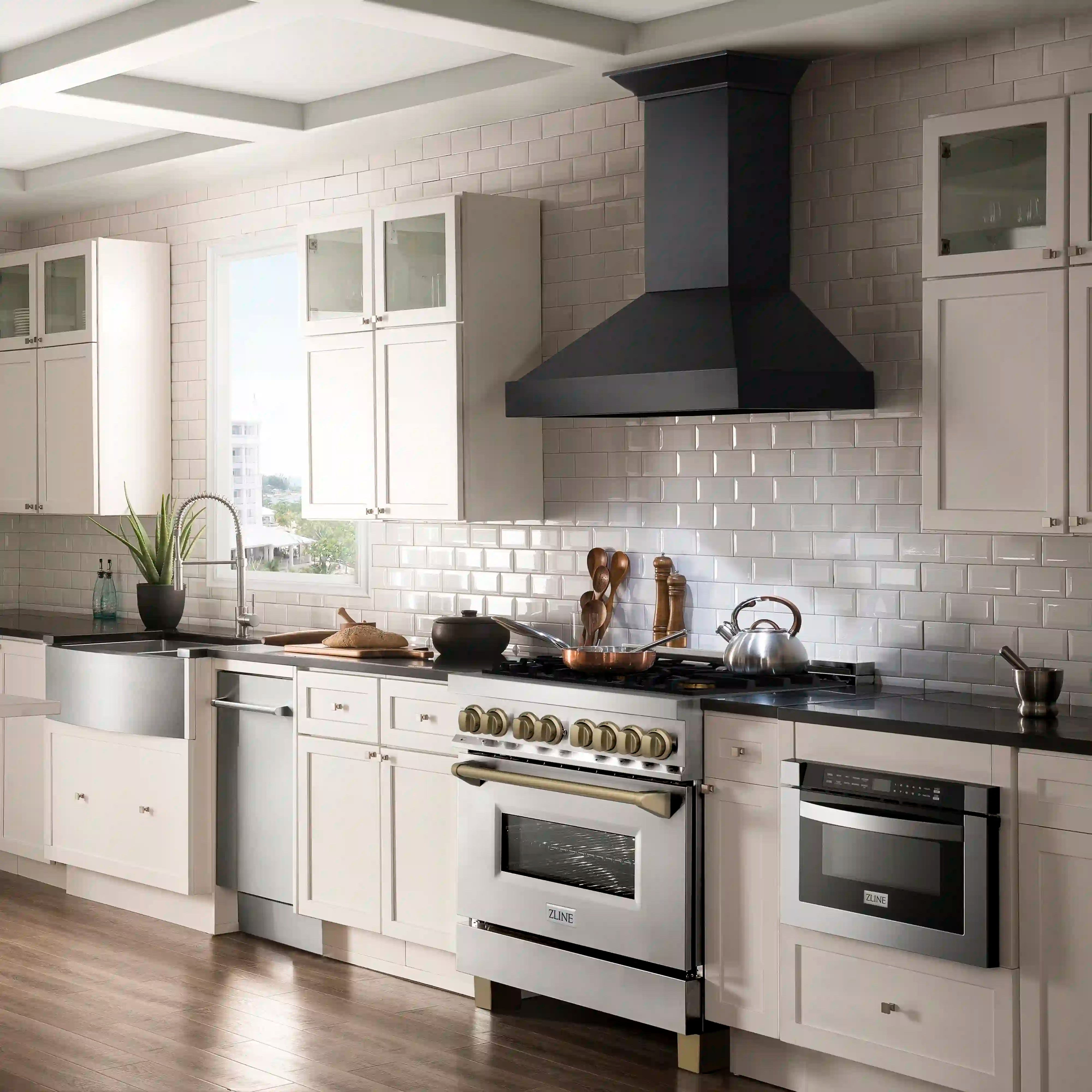 Stainless dual fuel range with bronze control knobs and built-in electric ovens