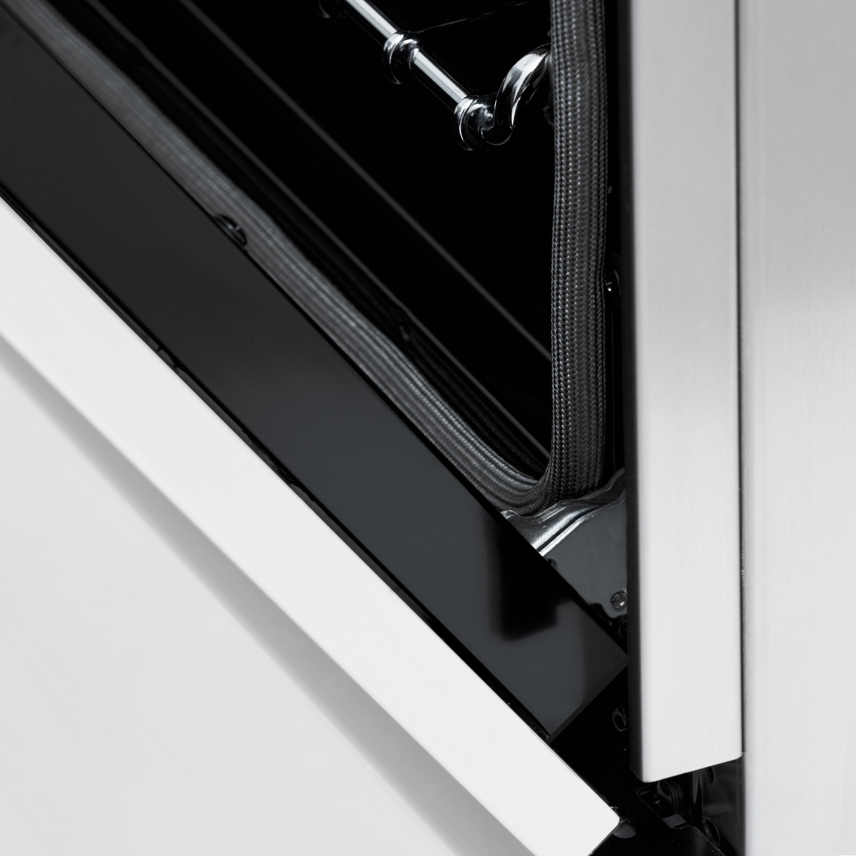Stainless dual fuel range door edge with black gasket and trim detail