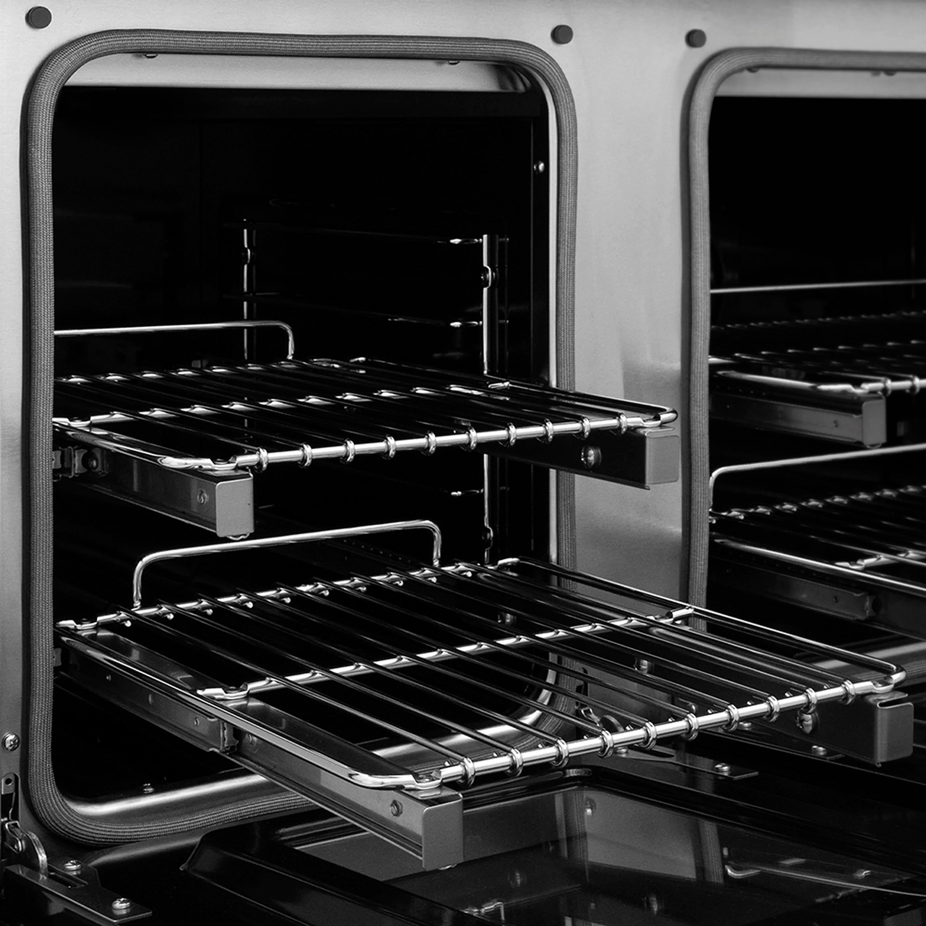 Dual oven interior with black racks and wire shelves on stainless range
