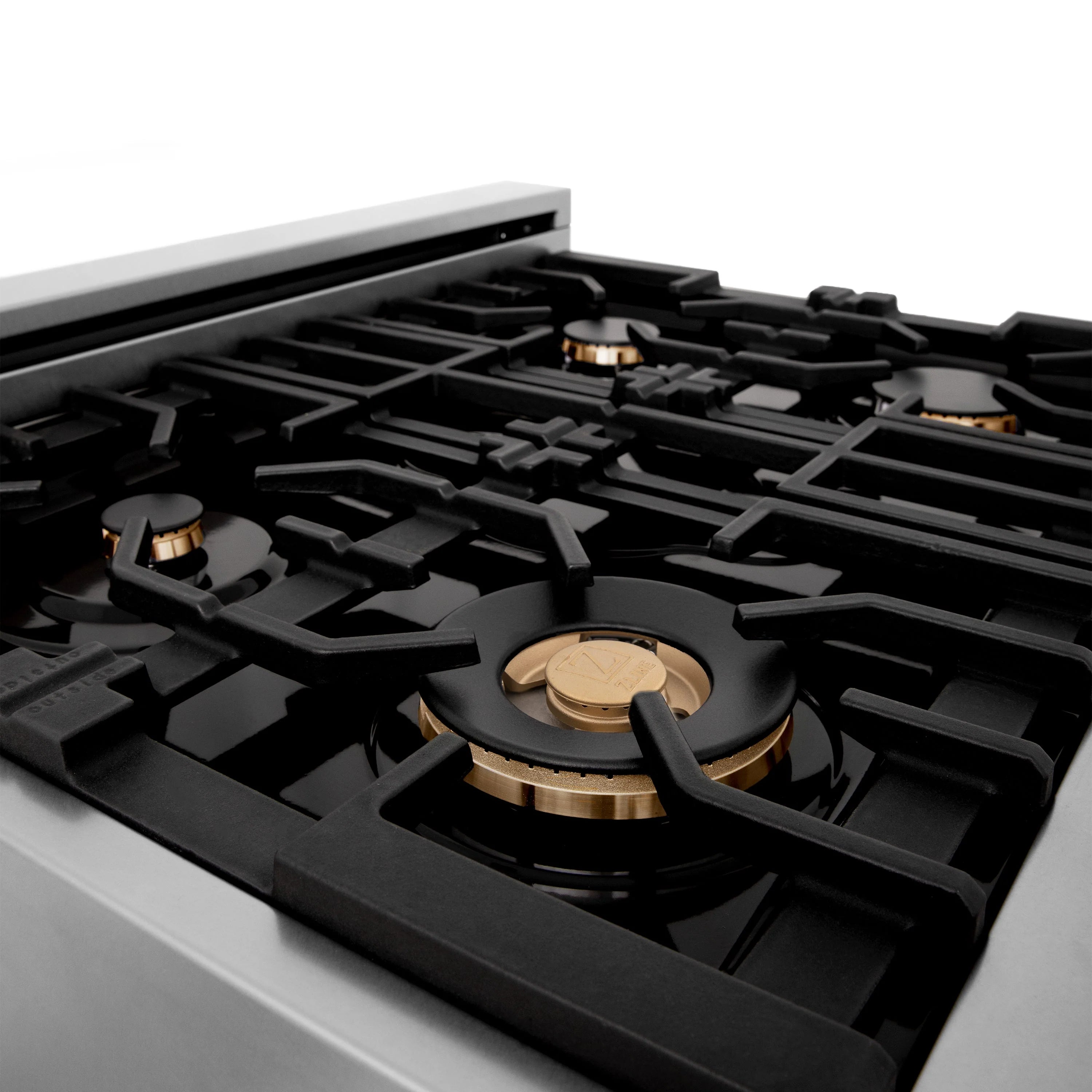 White gas cooktop with black grates and brass burner caps arranged across burners