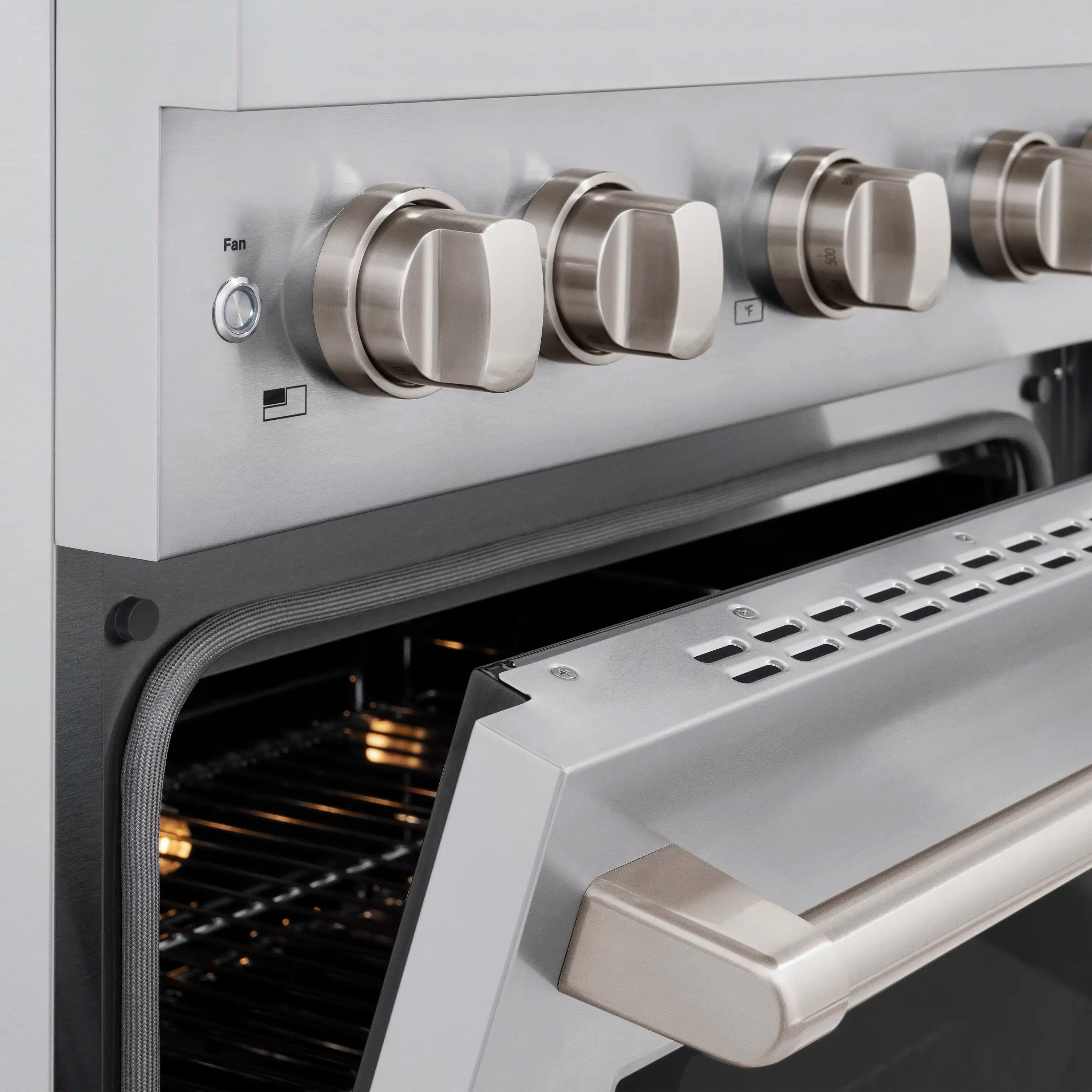 Dual-fuel range control panel with Fan knob and vented drawer under open oven