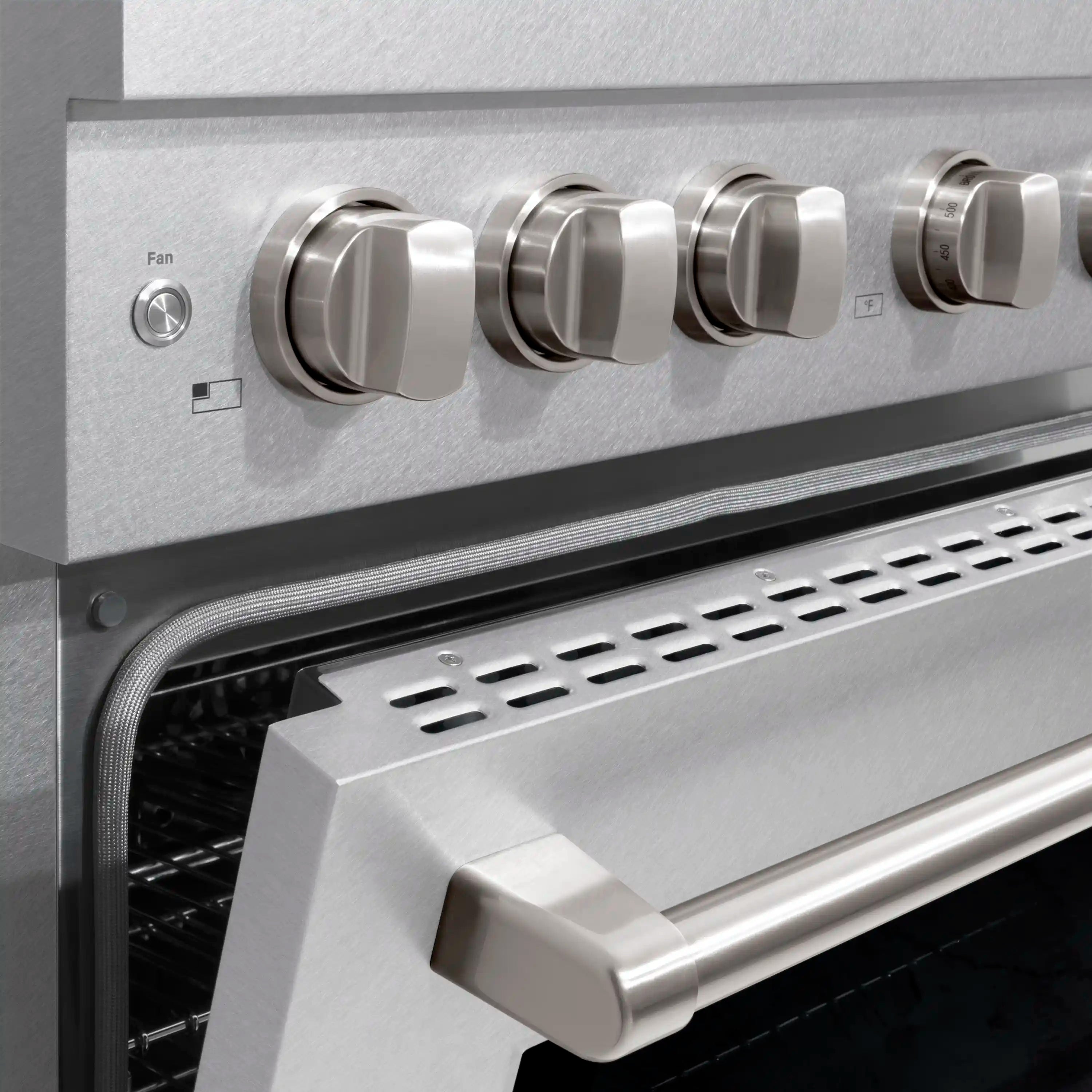 Front control knobs and oven handle on satin stainless steel dual fuel range