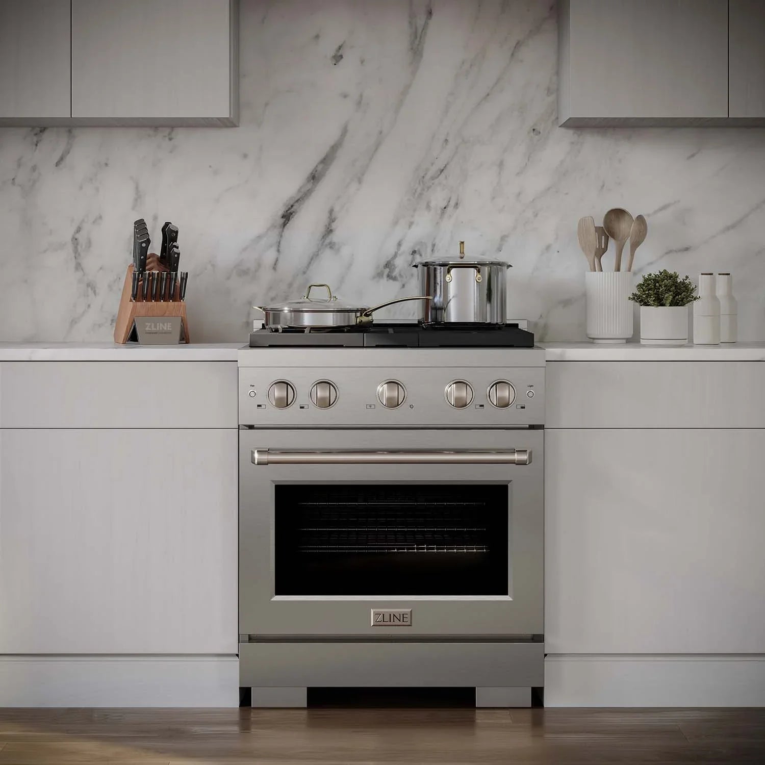 Stainless gas range installed in kitchen with drawers and cabinets